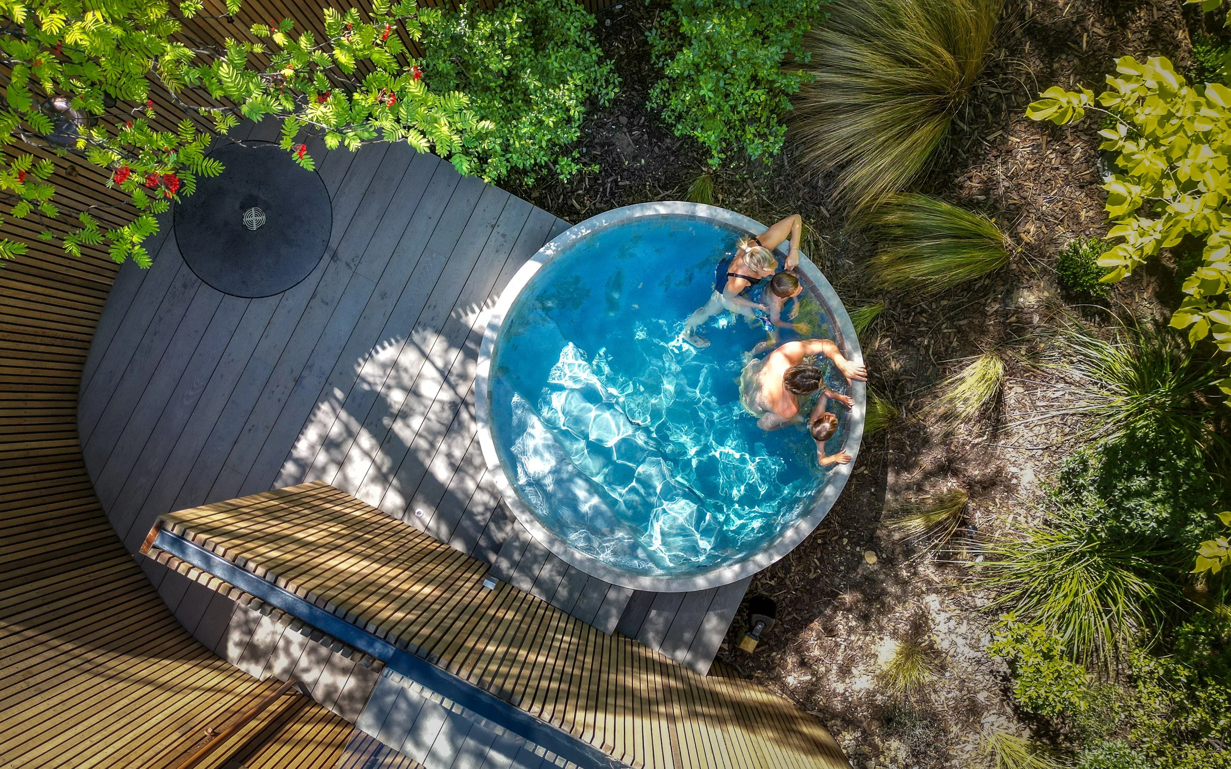A family spending quality time late afternoon Bathe Hot Pools Queenstown.