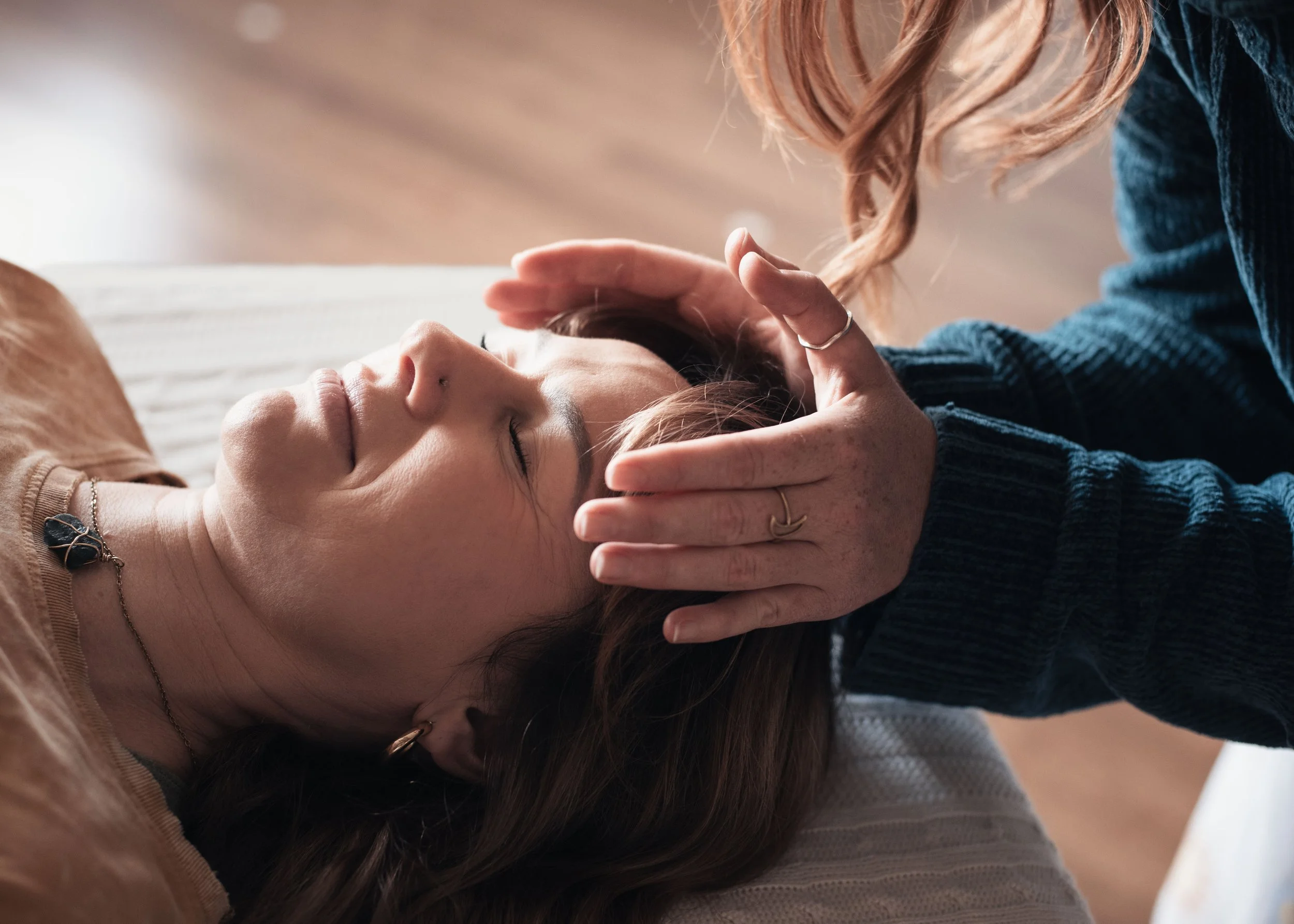 smiling woman receiving Reiki Holy Fire Healing