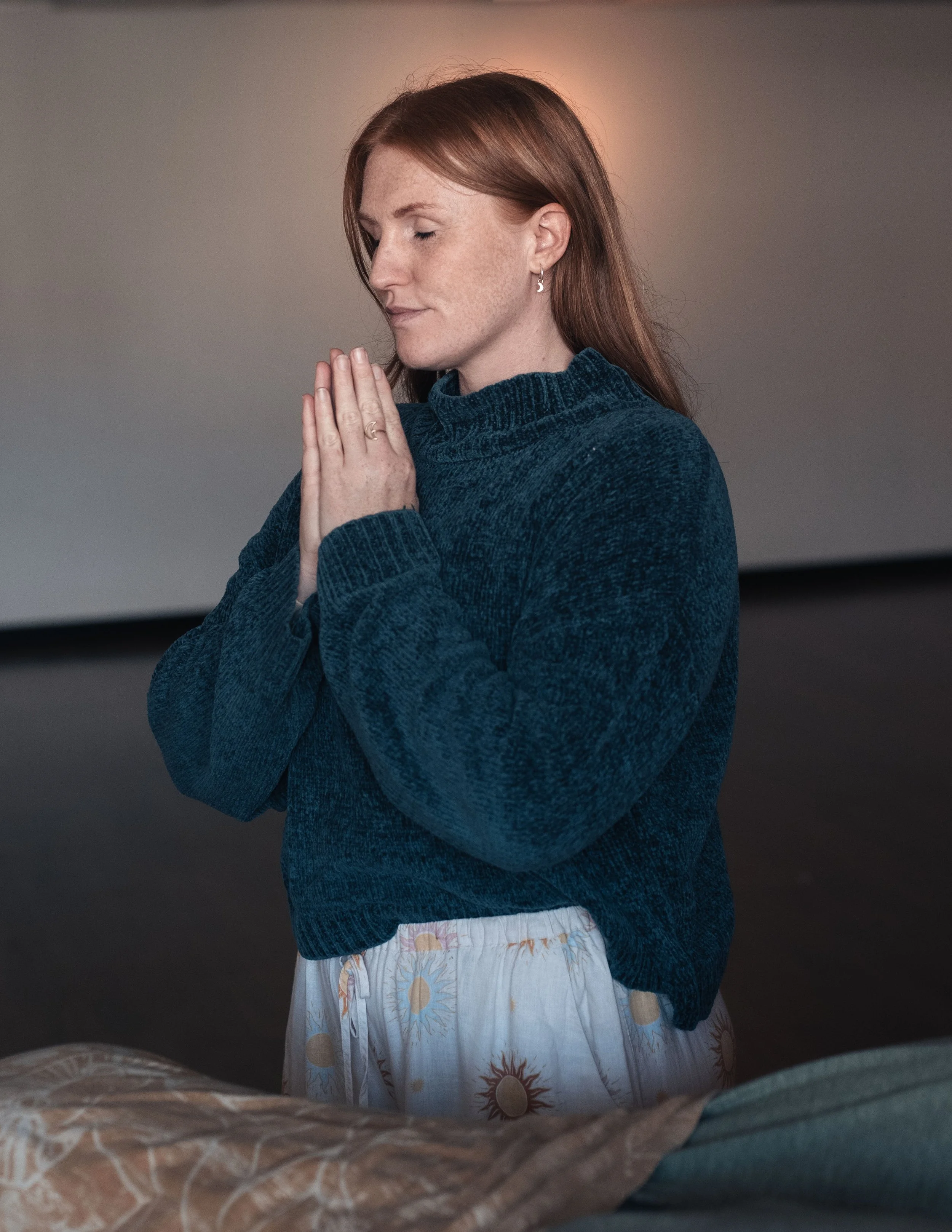 Woman with hands in prayer, channeling Reiki Holy Fire