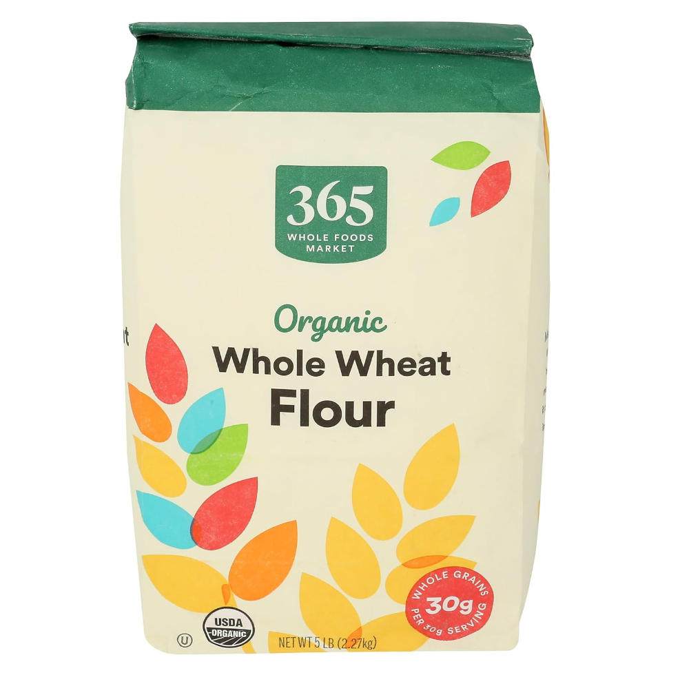 Package of 365 Whole Foods Market organic whole wheat flour with colorful leaf design and USDA organic certification label.