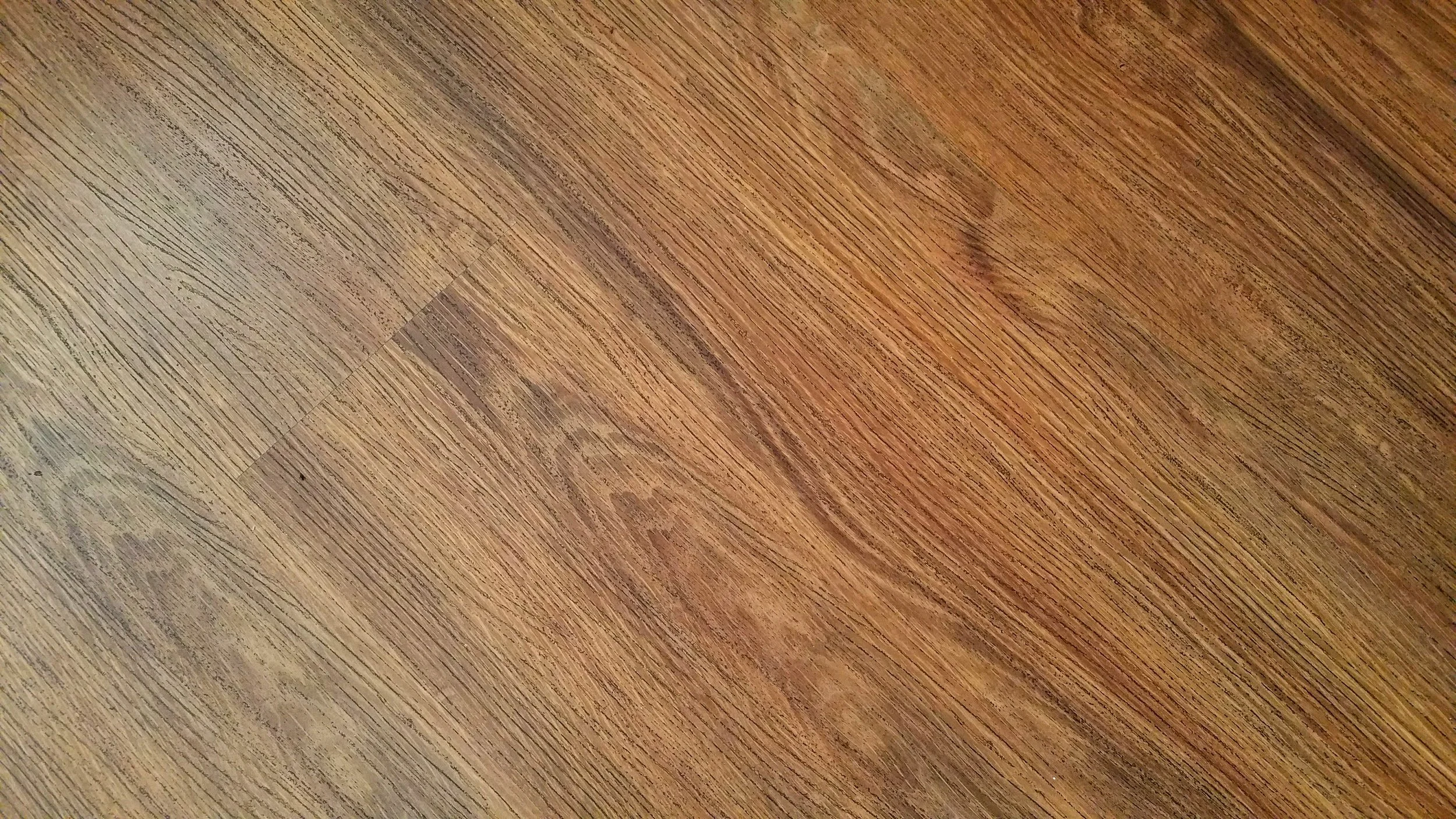 example of LVP up close which shows a distinctly different texture than authentic hardwood floor
