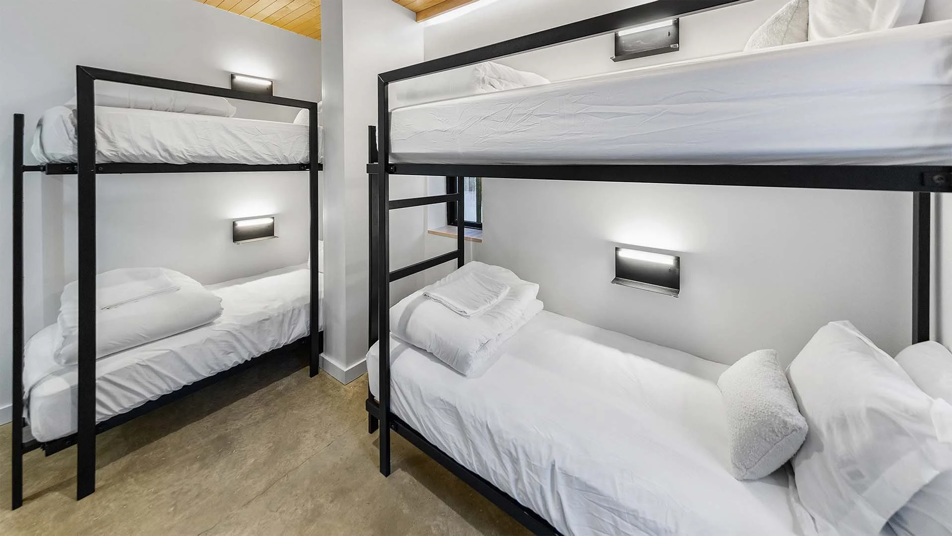 RAVN HAUS vacation rental Elevate Bunk Room with custom black bunks, reading lights, and charging in Government Camp, Oregon.