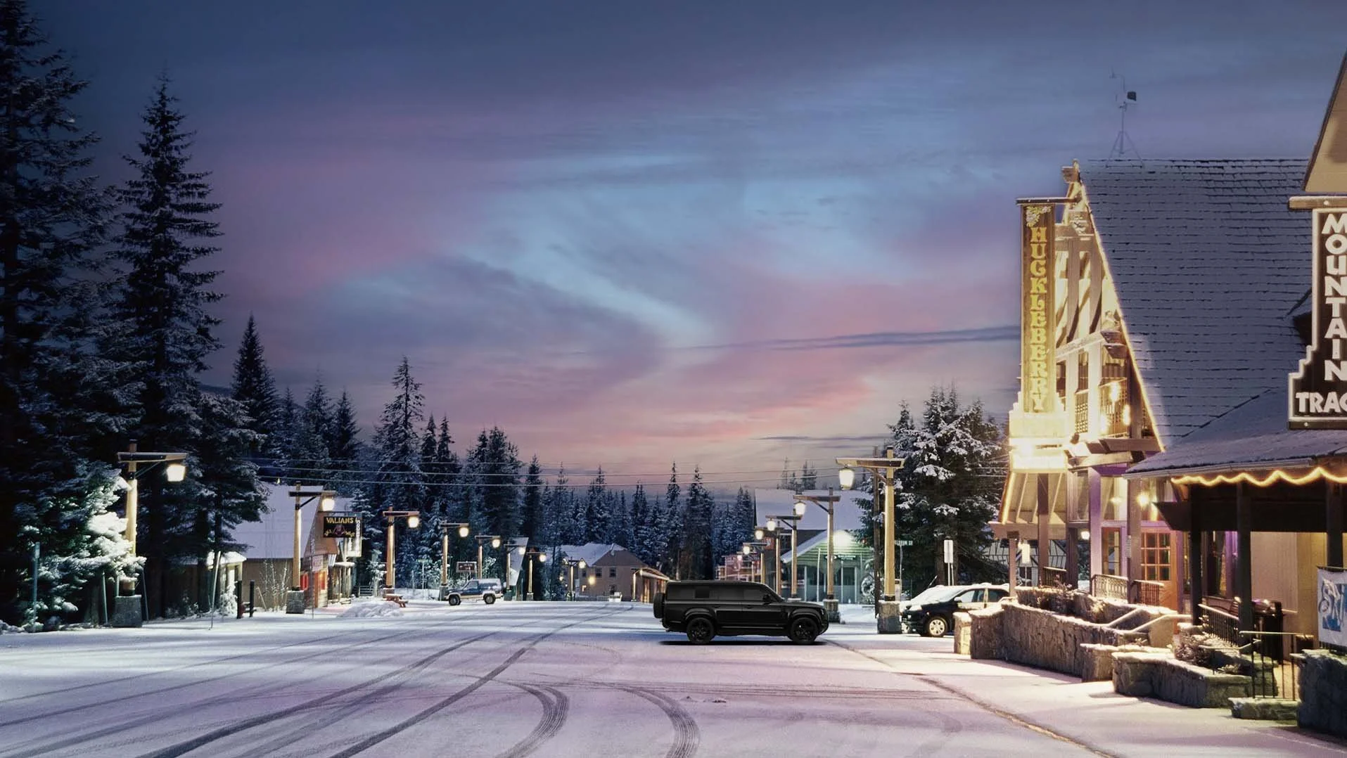 Snowy twilight street scene in Government Camp, Oregon, with cozy Mt. Hood restaurants and bars glowing against a winter sky near RAVN HAUS modern alpine vacation rental, ideal for après-ski dining and drinks.