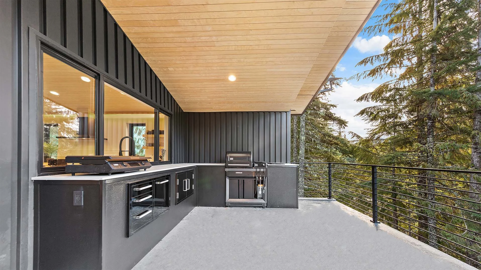 RAVN HAUS vacation rental Cornice Deck pass-through window connecting outdoor grill to Ridge Kitchen, Oregon.