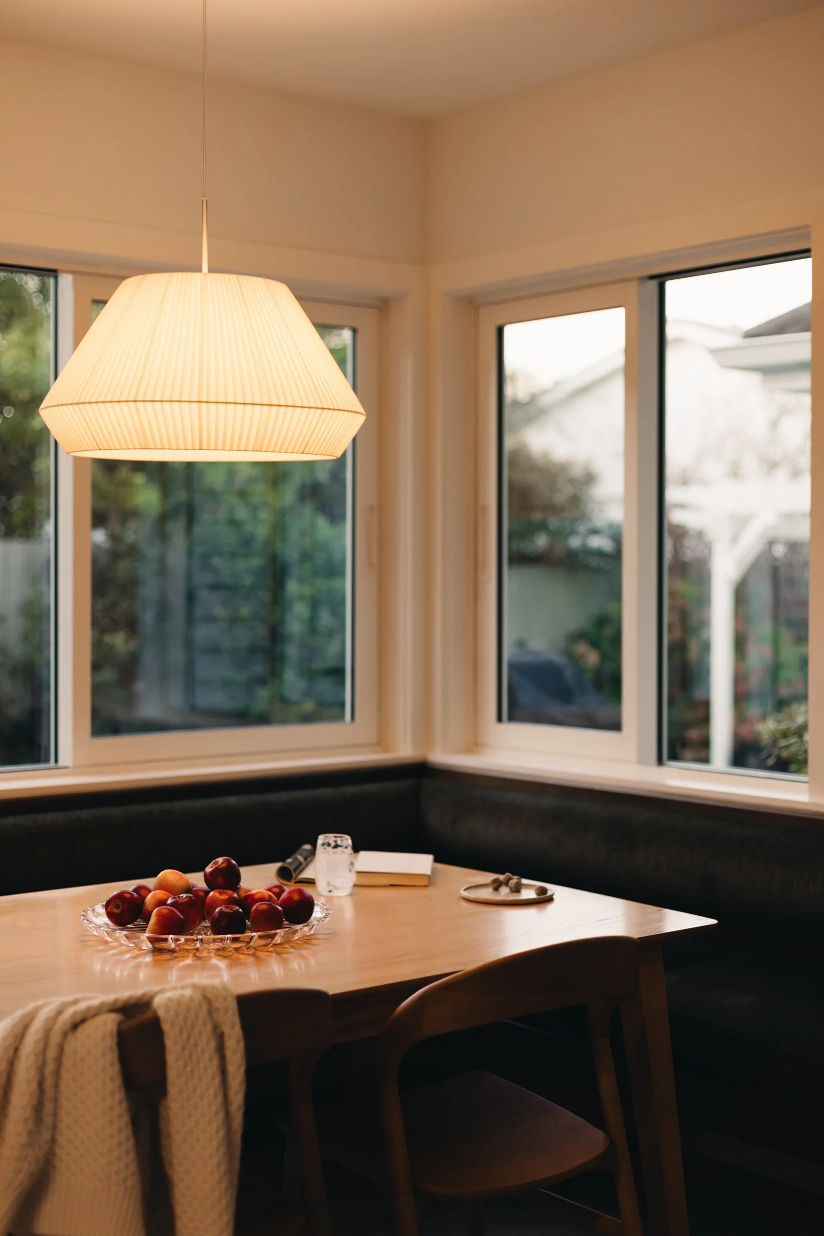 Warm family kitchen design NZ  with feature light - Honour Creative.