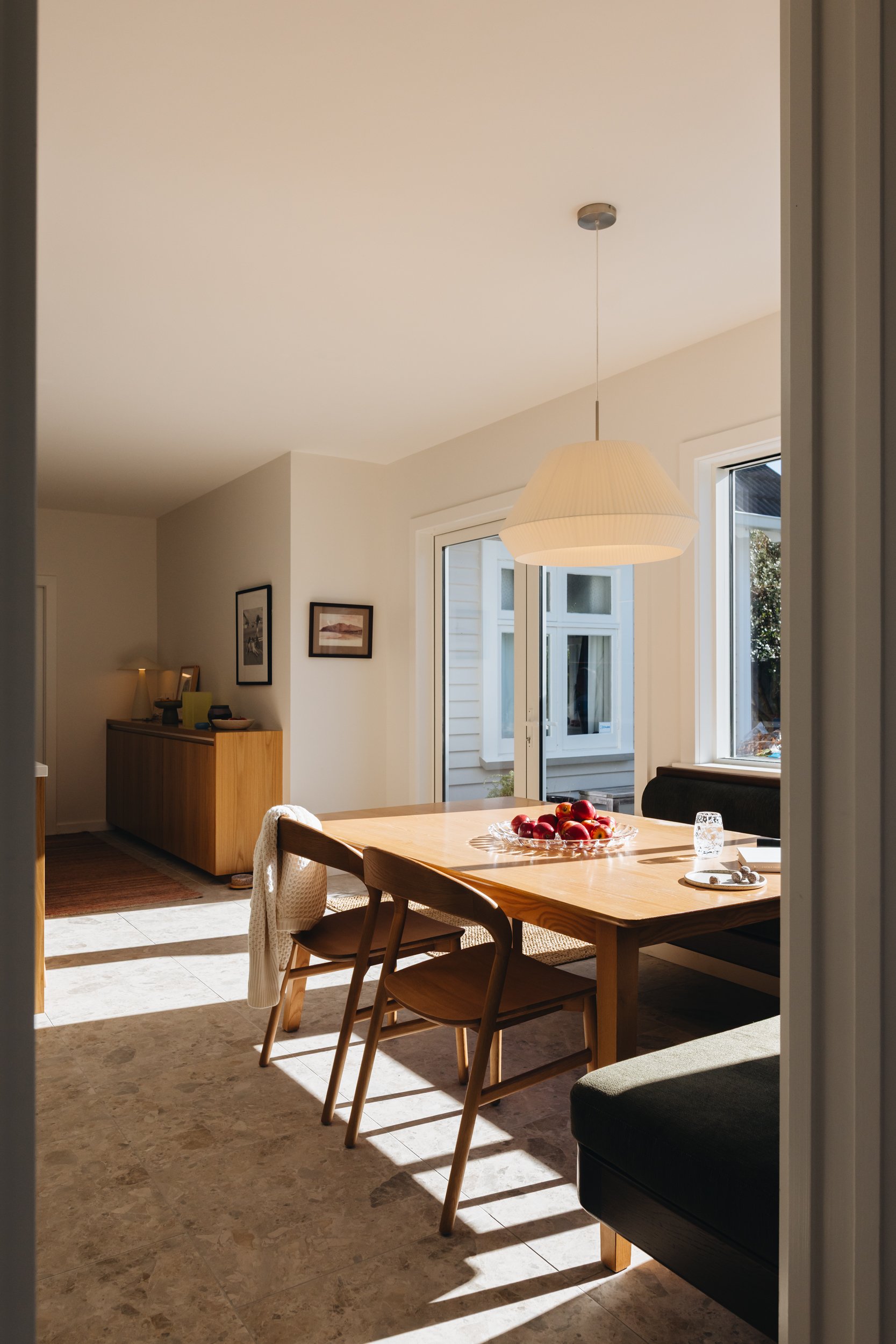 Warm family kitchen design NZ  with breakfast nook - Honour Creative.