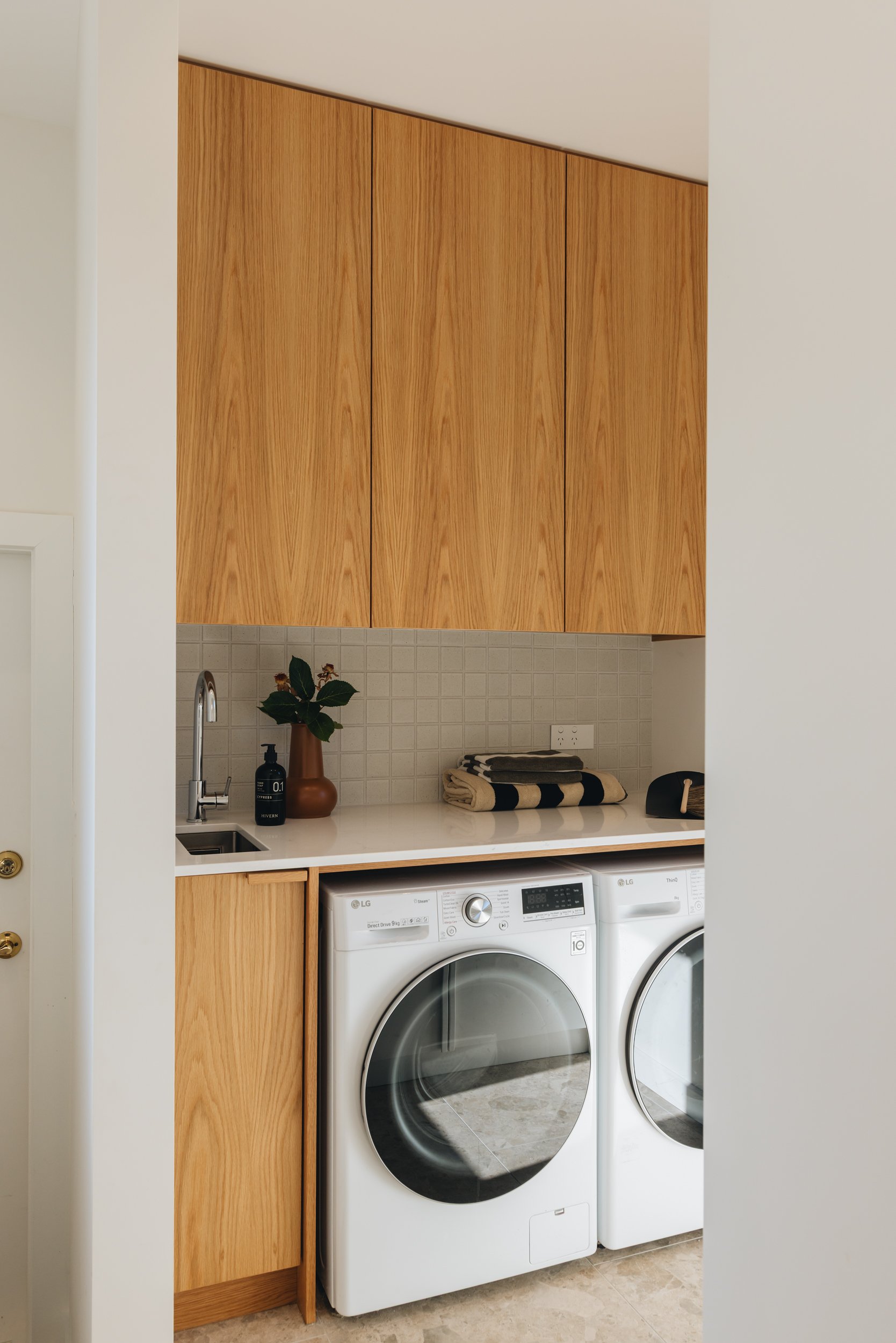 Warm family kitchen design NZ attached laundry - Honour Creative.