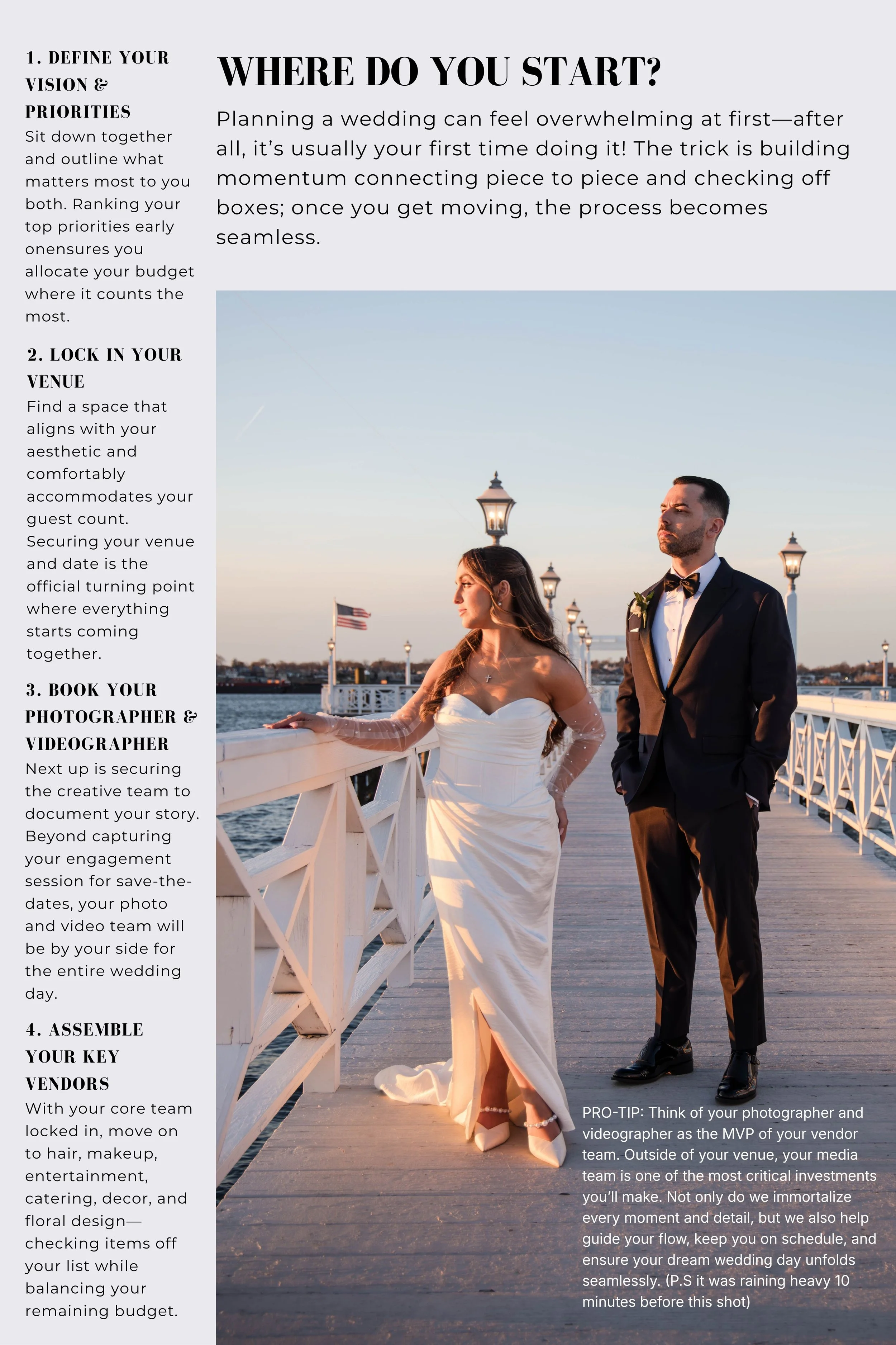 A bride and groom stand on a wooden dock during sunset, with the bride wearing a white wedding gown and the groom in a black tuxedo with a bow tie. The background features a lake with boats, American flags, and decorative lampposts.