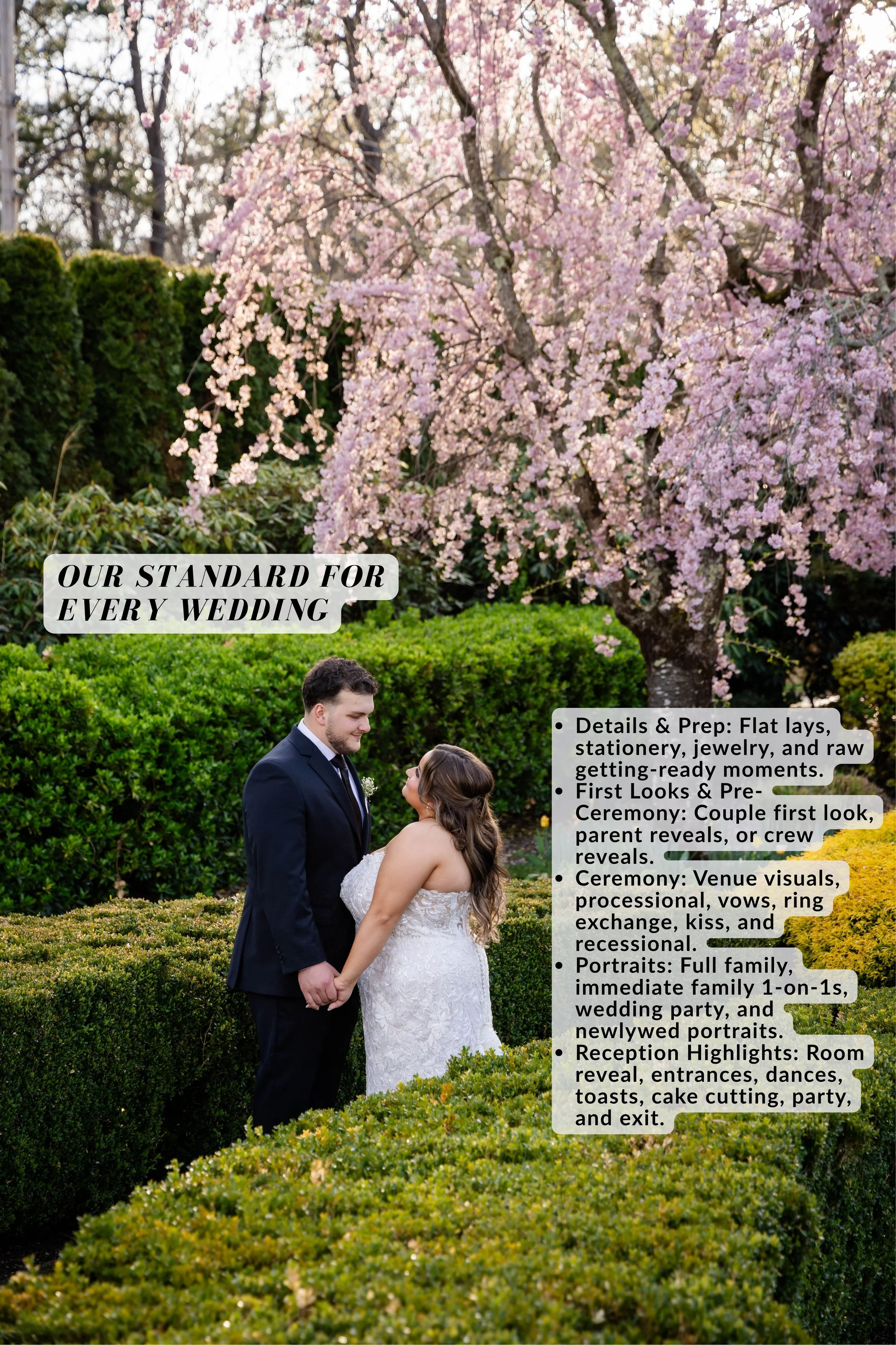 A bride and groom holding hands outdoors during a wedding ceremony, surrounded by well-manicured bushes and trees with pink blossoms, likely in spring.