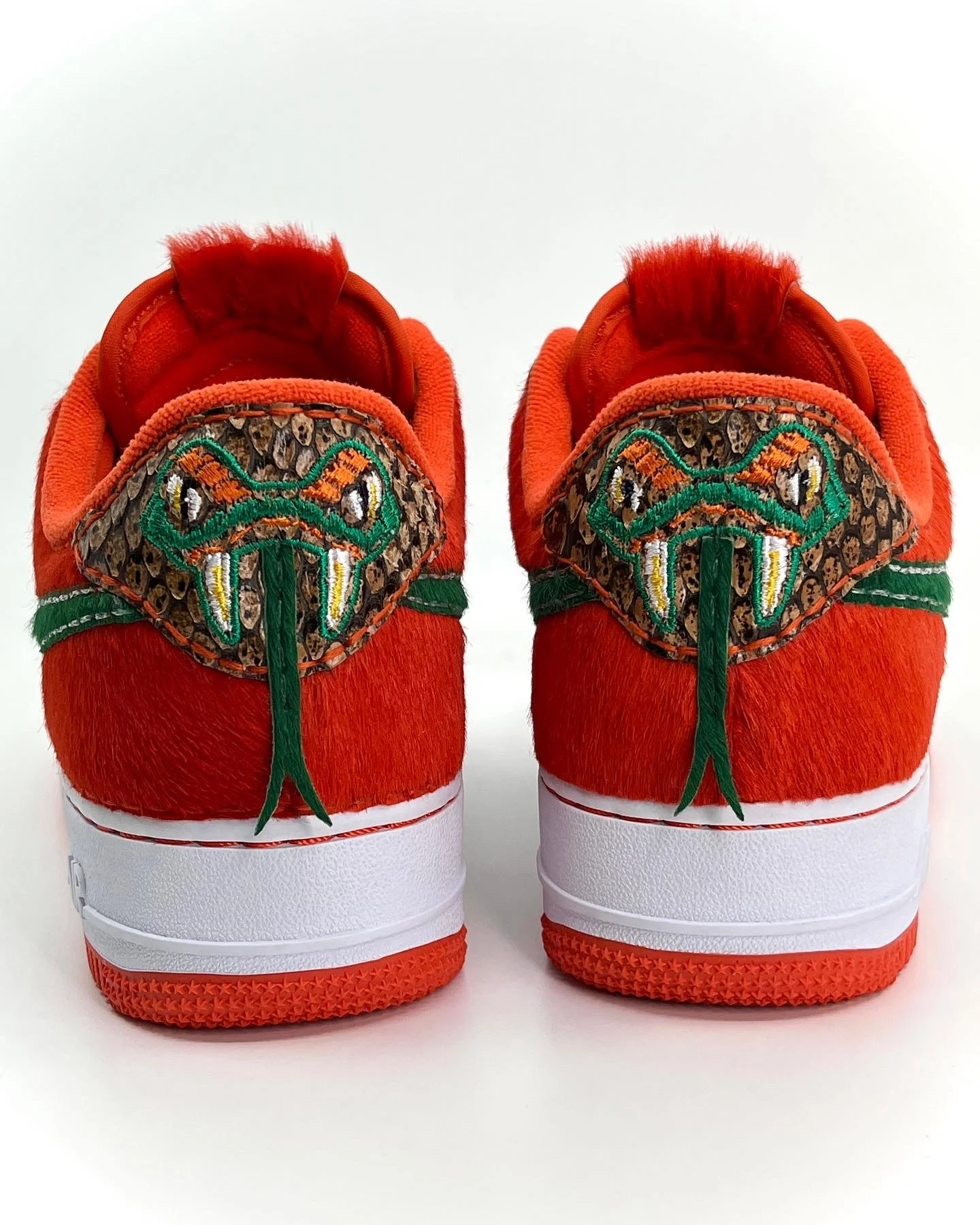 Heels of the "Rattlers - Home" Nike Air Force 1. Decorative heel embroidery with pony applique. Leathers used: Sedona Anaconda, Green Pony, Orange Pony Hair.