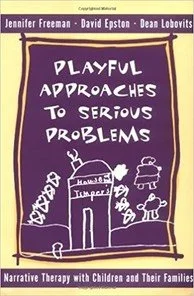 Book cover titled 'Playful Approaches to Serious Problems' with authors Jennifer Freeman, David Epston, and Dean Lobovits. The cover features a purple background with simple white line drawings of a house, trees, and playful shapes.