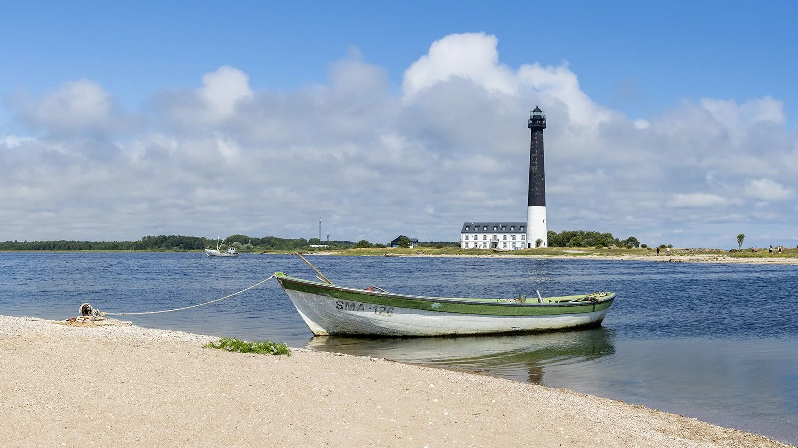 A small boat docked on a sandy beach in Sõrve peninsula in Saaremaa island, Estonia.
