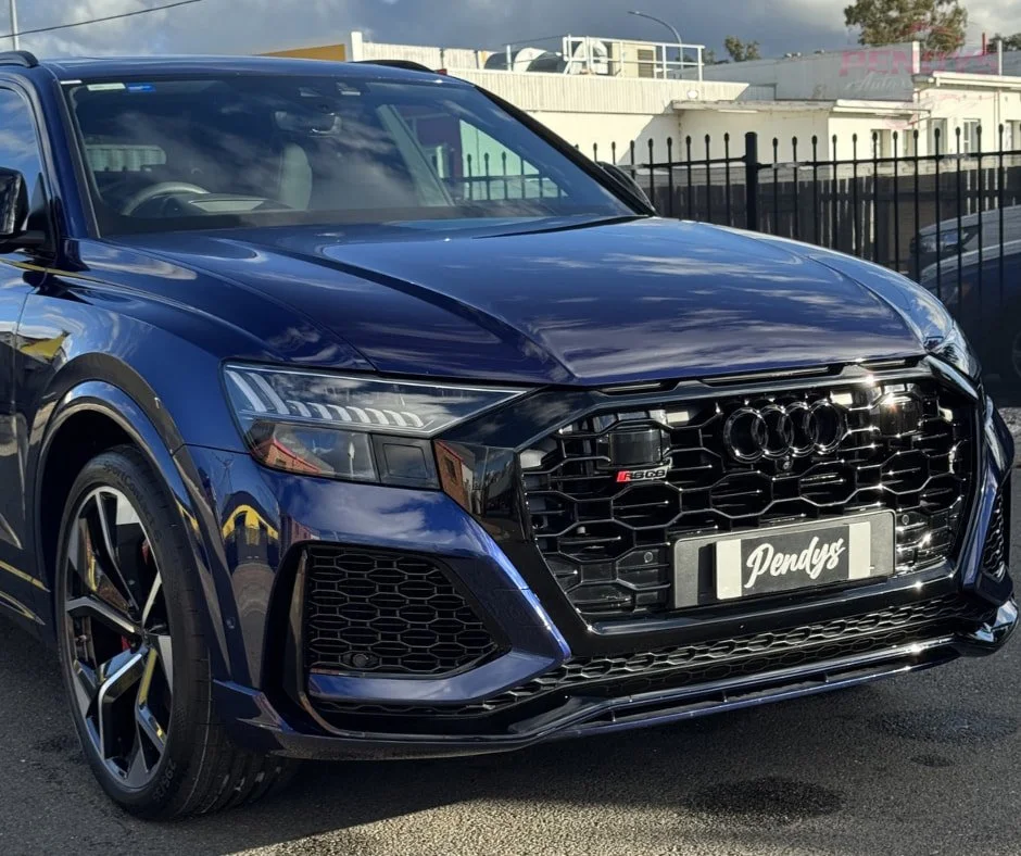 Blue Audi SUV with a glossy finish, viewed from the front at an angle.