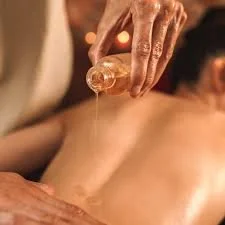A person receiving a massage with massage oil applied to their back