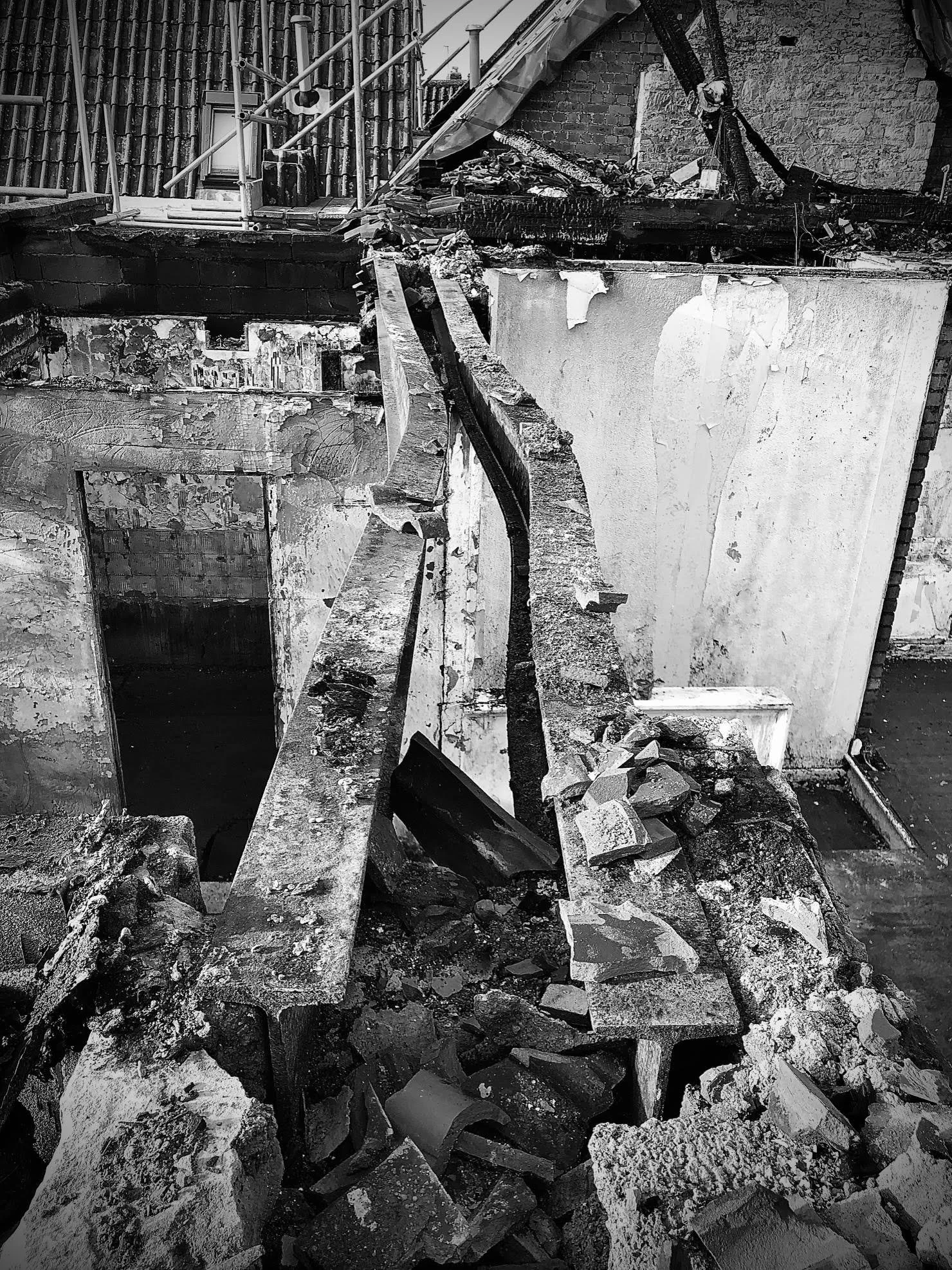bendy fire damaged beams at a post-fire dangerous building structural inspection