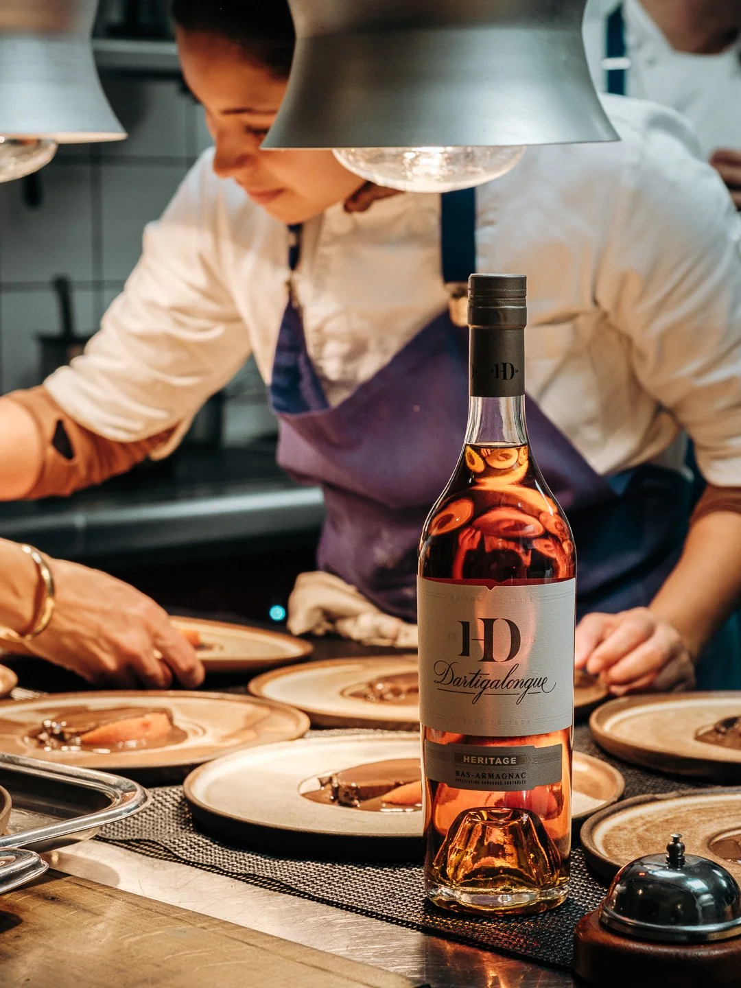 Bouteille de Bas-Armagnac Dartigalongue devant un service en cuisine gastronomique