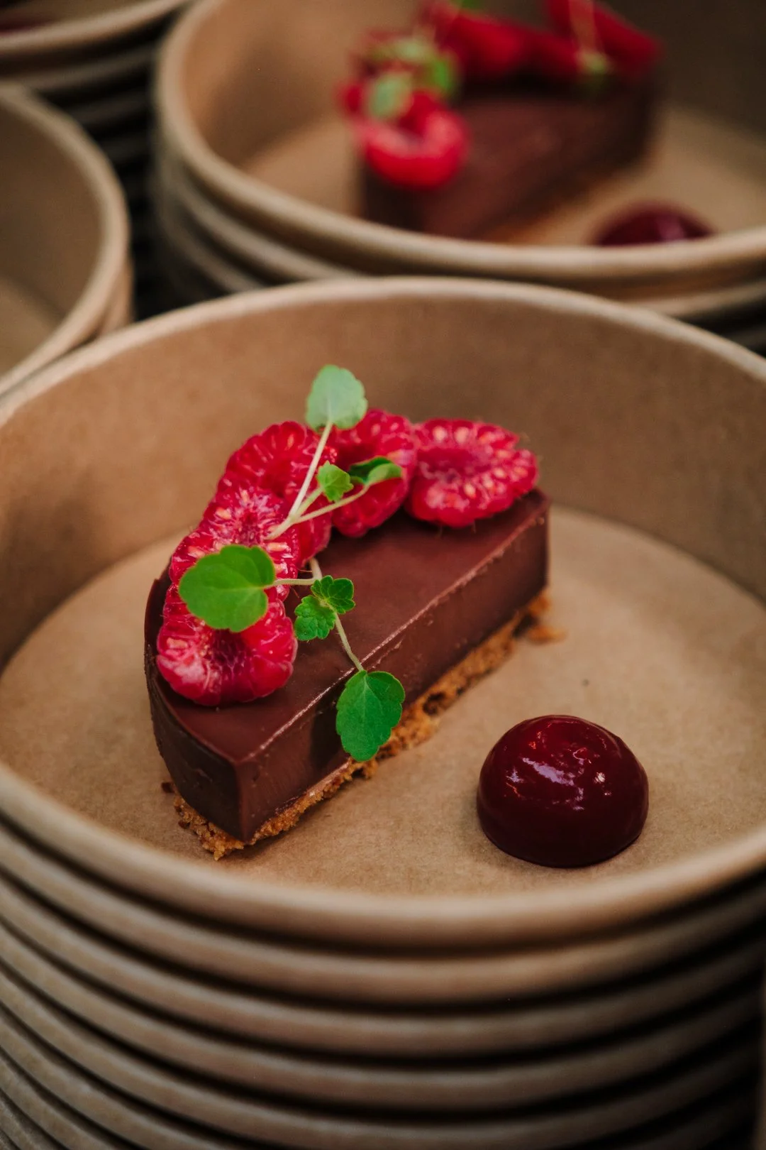 Tapas dessert : part de tarte chocolat framboise dans coupelle kraft