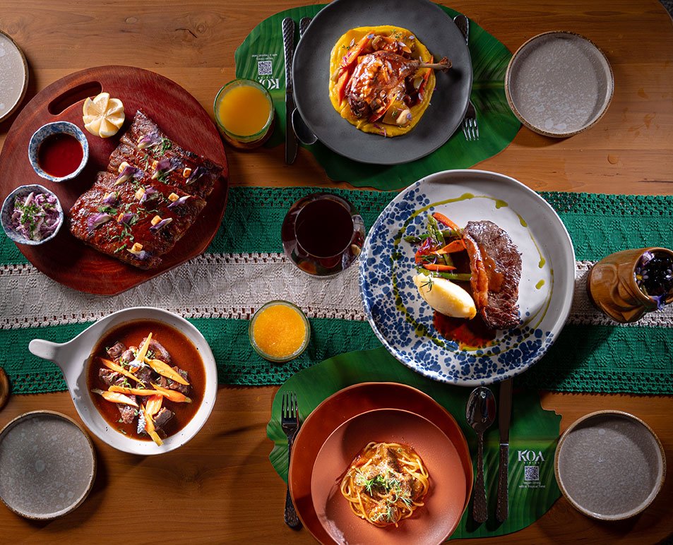 A top-down view of a beautifully arranged meal featuring various assorted dishes at Koa Dining, Tolani Koh Samui