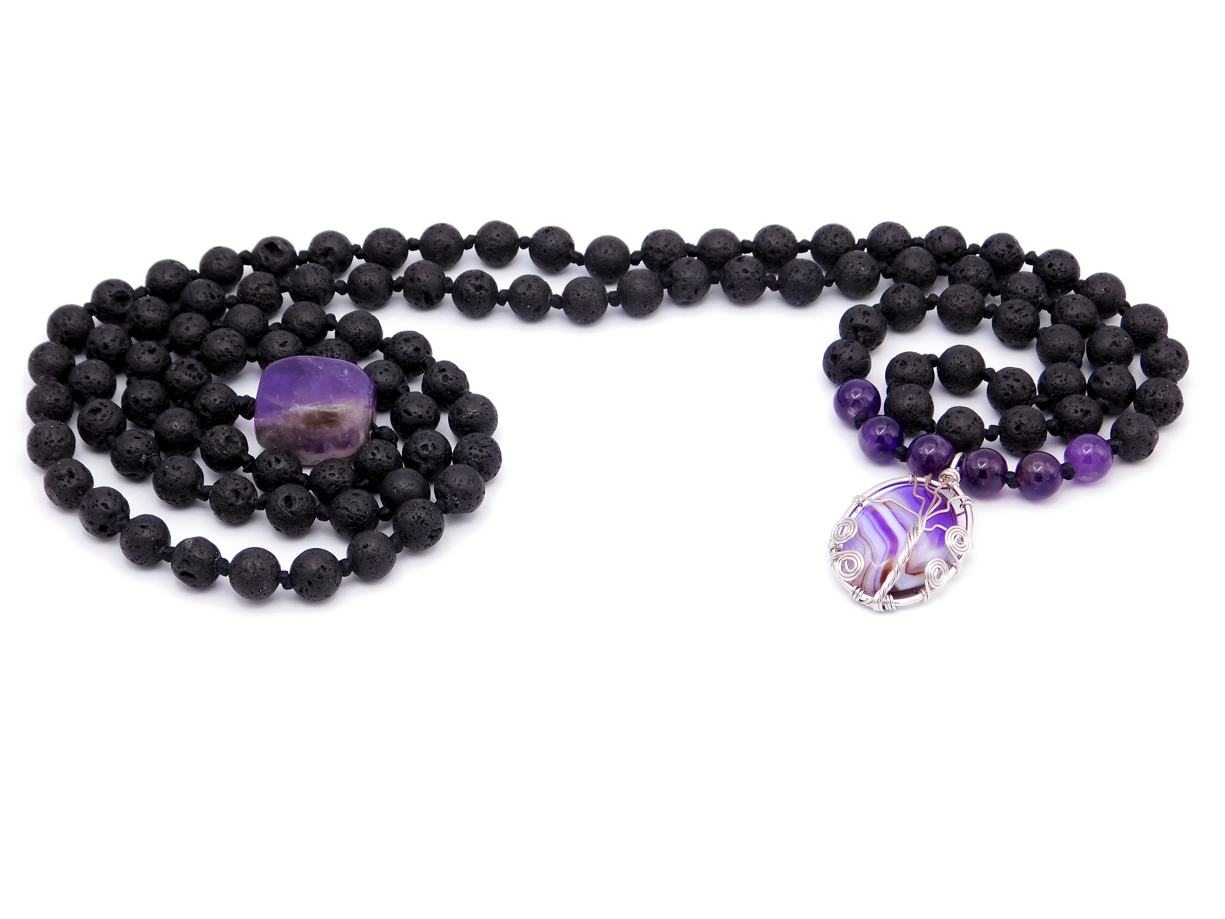 Black beaded necklaces with a purple stone pendant, purple beads, and silver wire wrapping on a white background.