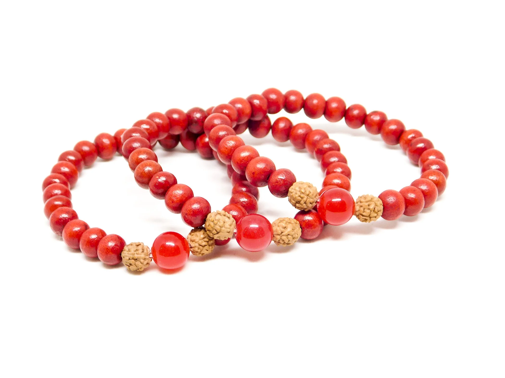 Three red beaded bracelets with beige seed beads on a white background.