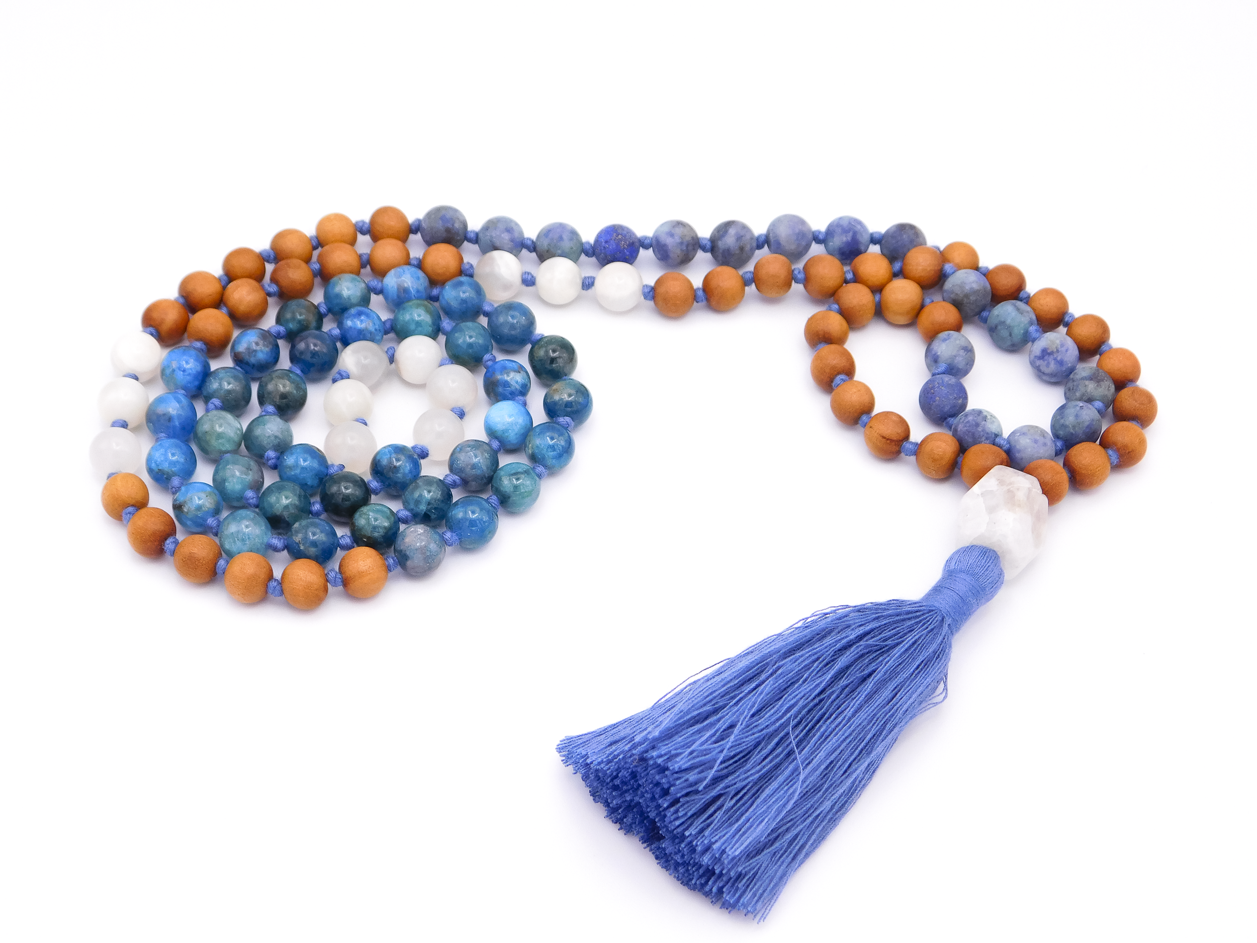 Blue, white, and brown beaded prayer necklace with a blue tassel on a white background.