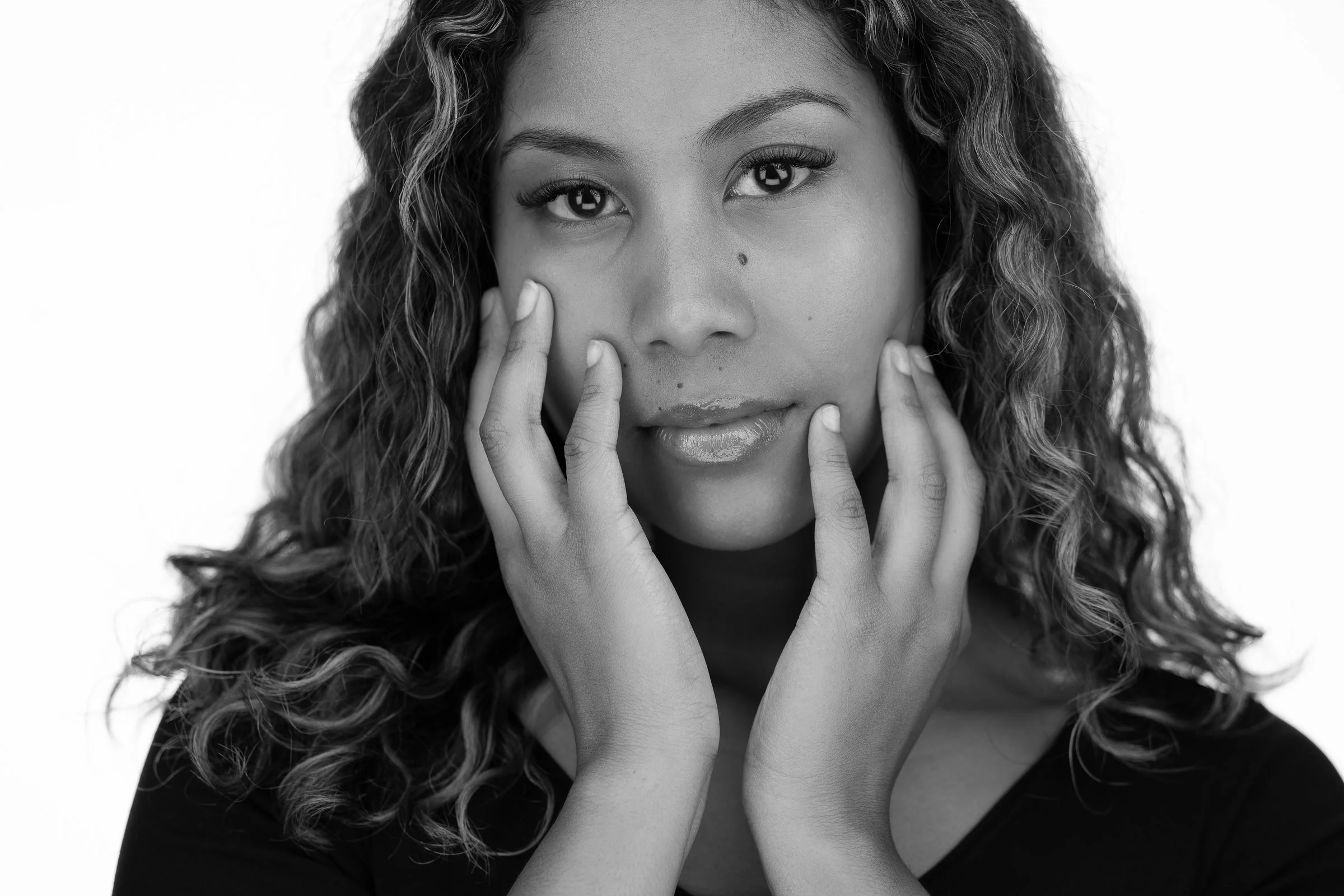 Black and white headshot of a woman with a thoughtful pose