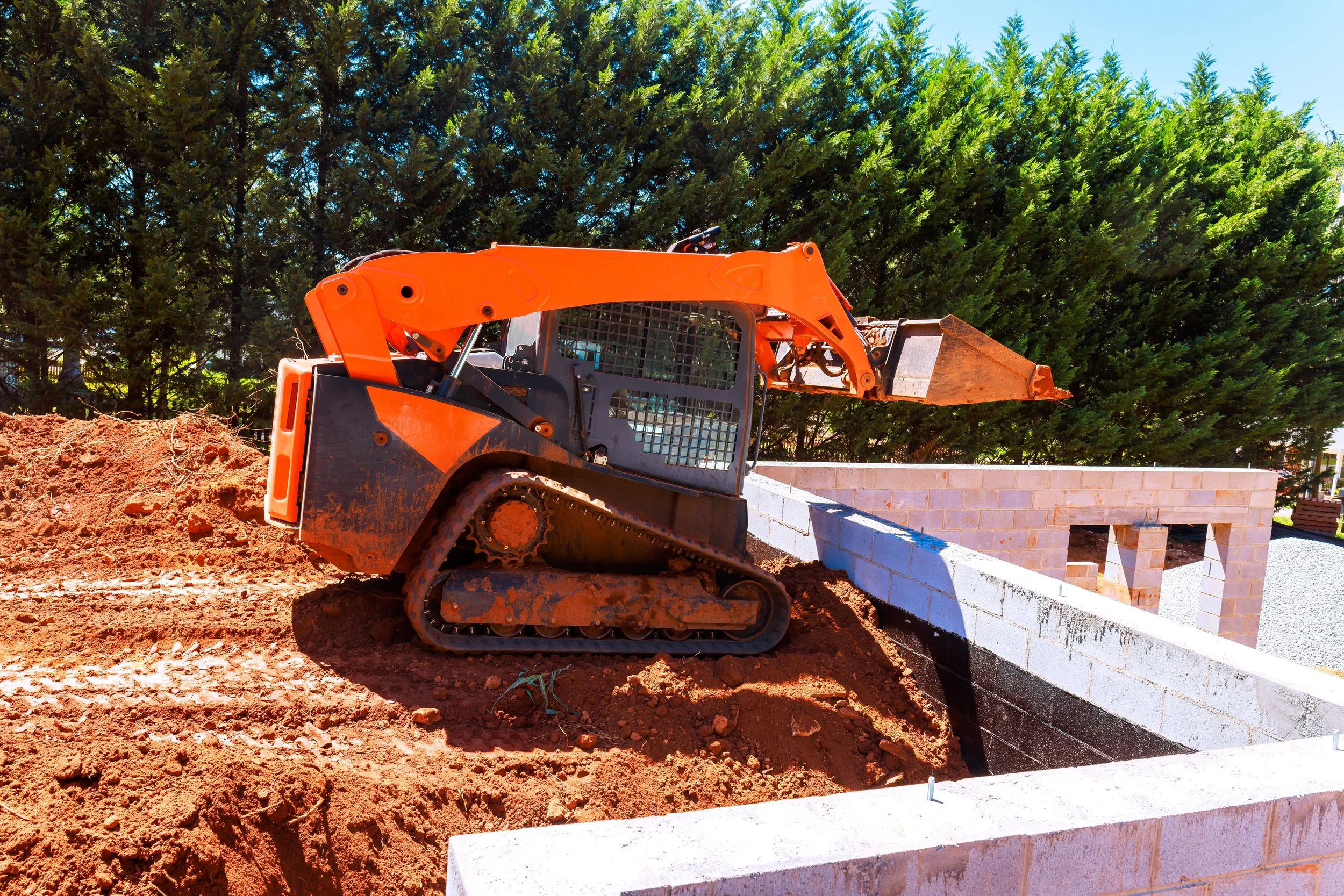 compact excavator rental working in tight residential construction area in Louisiana