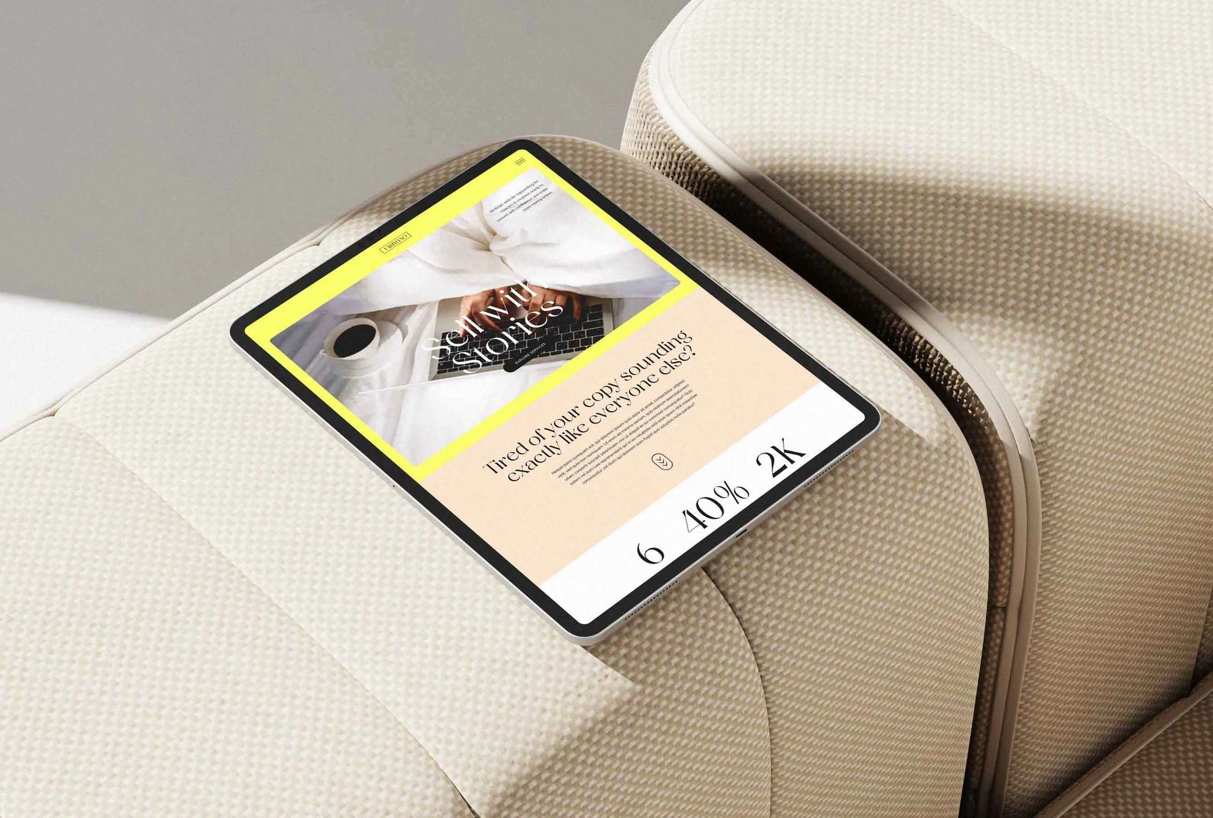 A minimalistic tablet mockup rests on a beige fabric cushion, showcasing a modern beautiful website's homepage dashboard.
