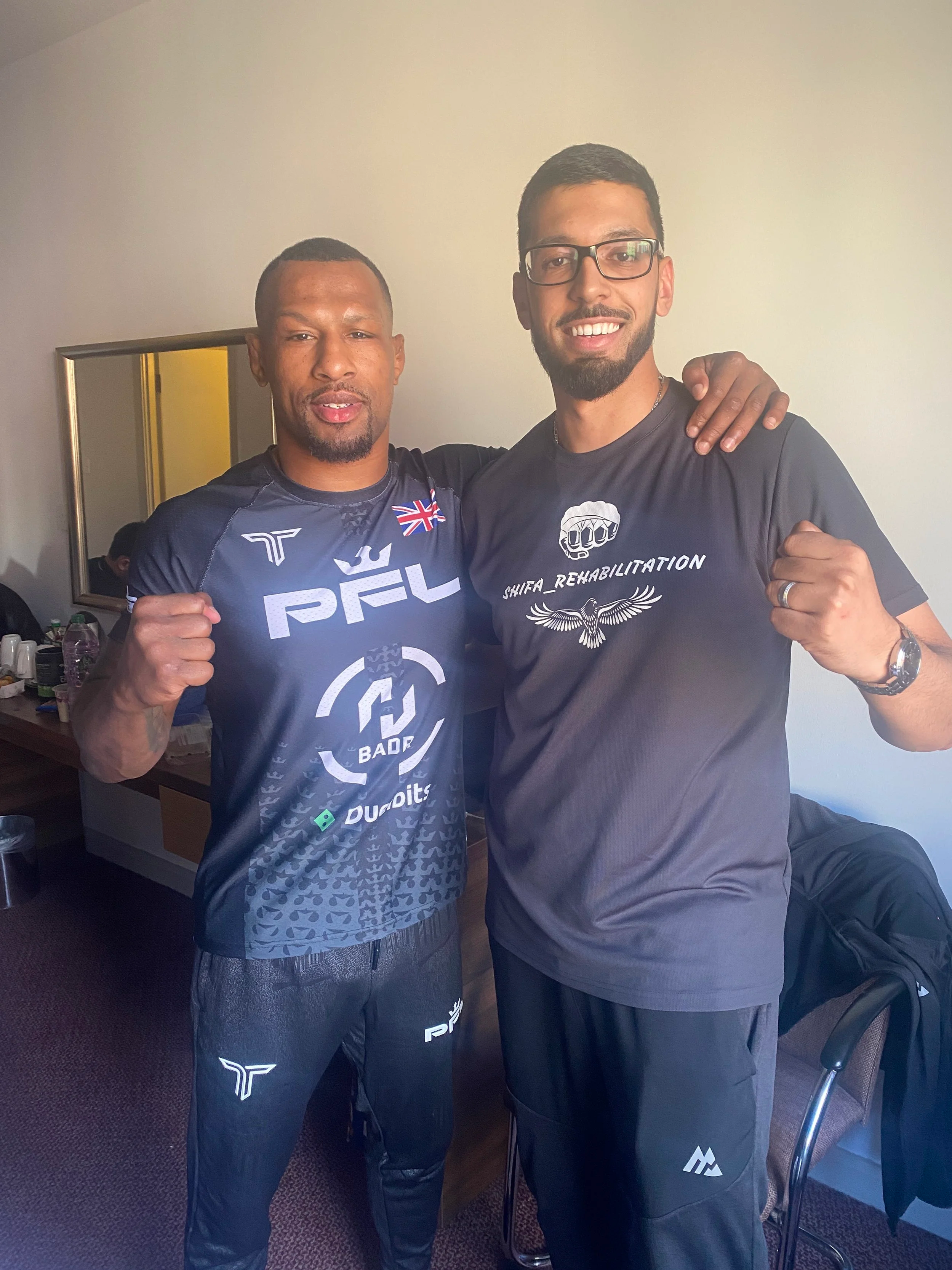 Shifa rehabilitation owner Bilal posing for a picture with professional mixed martial artist and Manchester native Kane Mousah, the founder of Badr clothing.