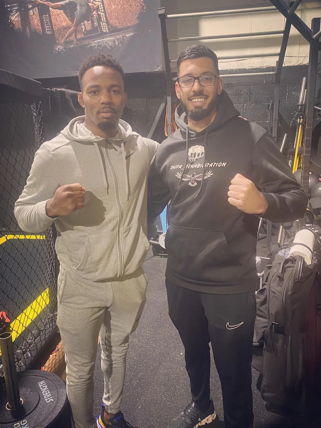 Shifa rehabilitation owner Bilal posing for a picture with professional mixed martial artist and Manchester native Lerone Murphy, a current Ultimate Fighting Championship (UFC) fighter.