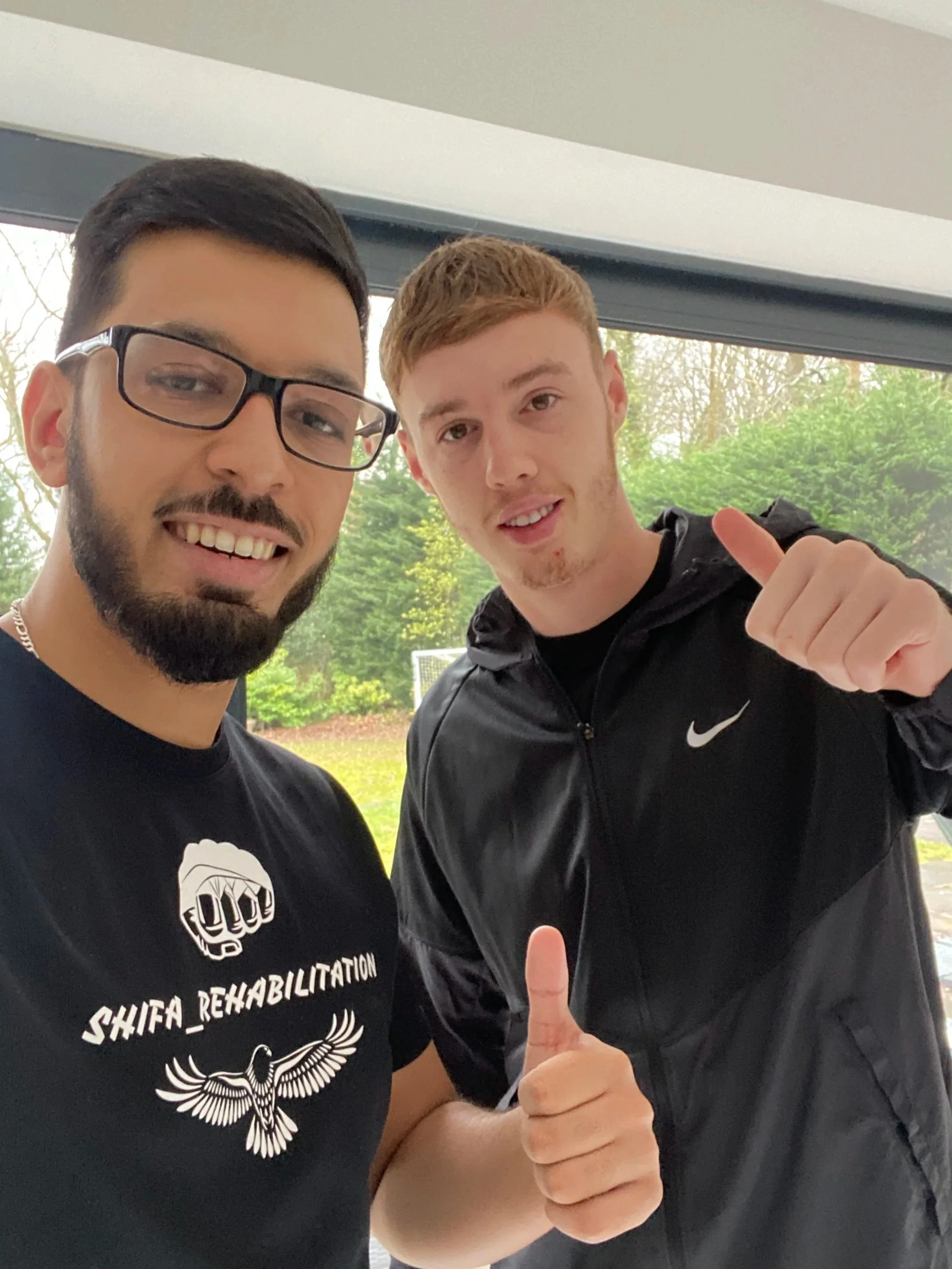 Shifa rehabilitation owner Bilal posing for a picture with for Manchester City, current Chelsea & England international footballer Cole Palmer after a successful treatment session