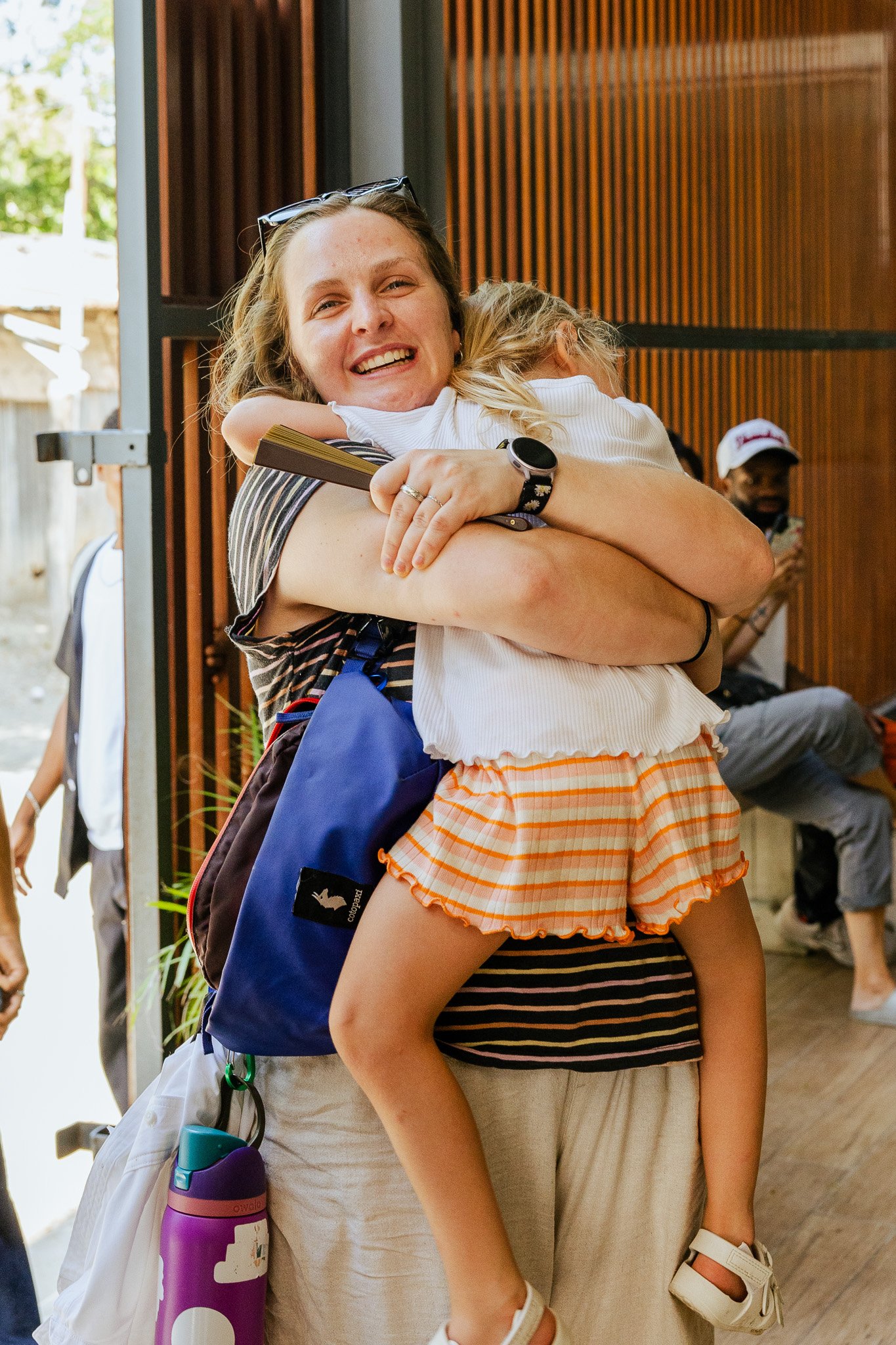 A person from Antioch Community Church in Chandler embracing a child