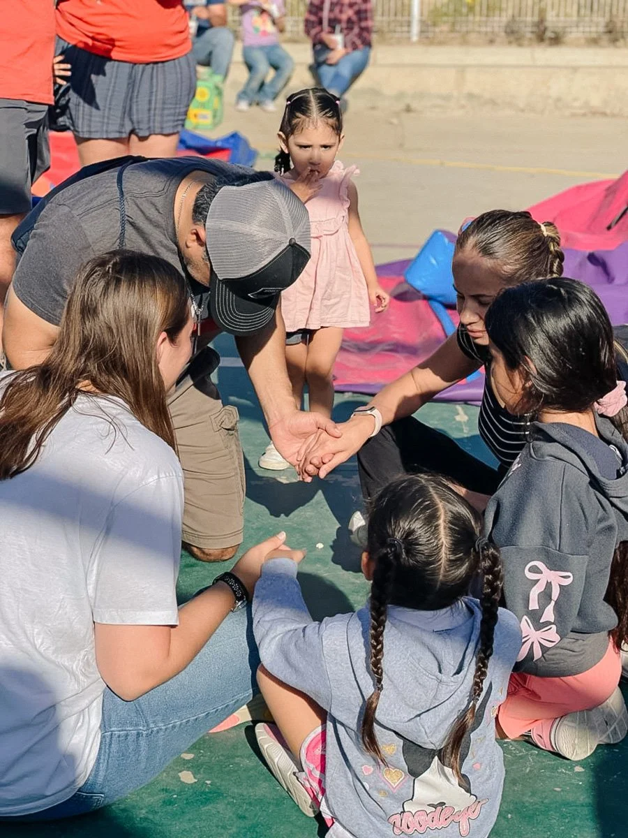 a group of college students from Antioch Community Church in Chandler praying together on an outreach.