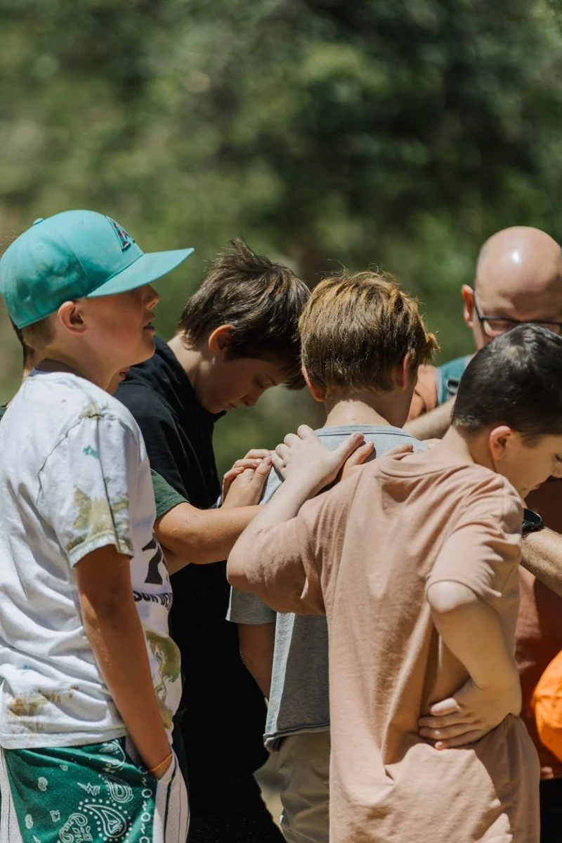 Youth boys praying together from Antioch Community Church youth group