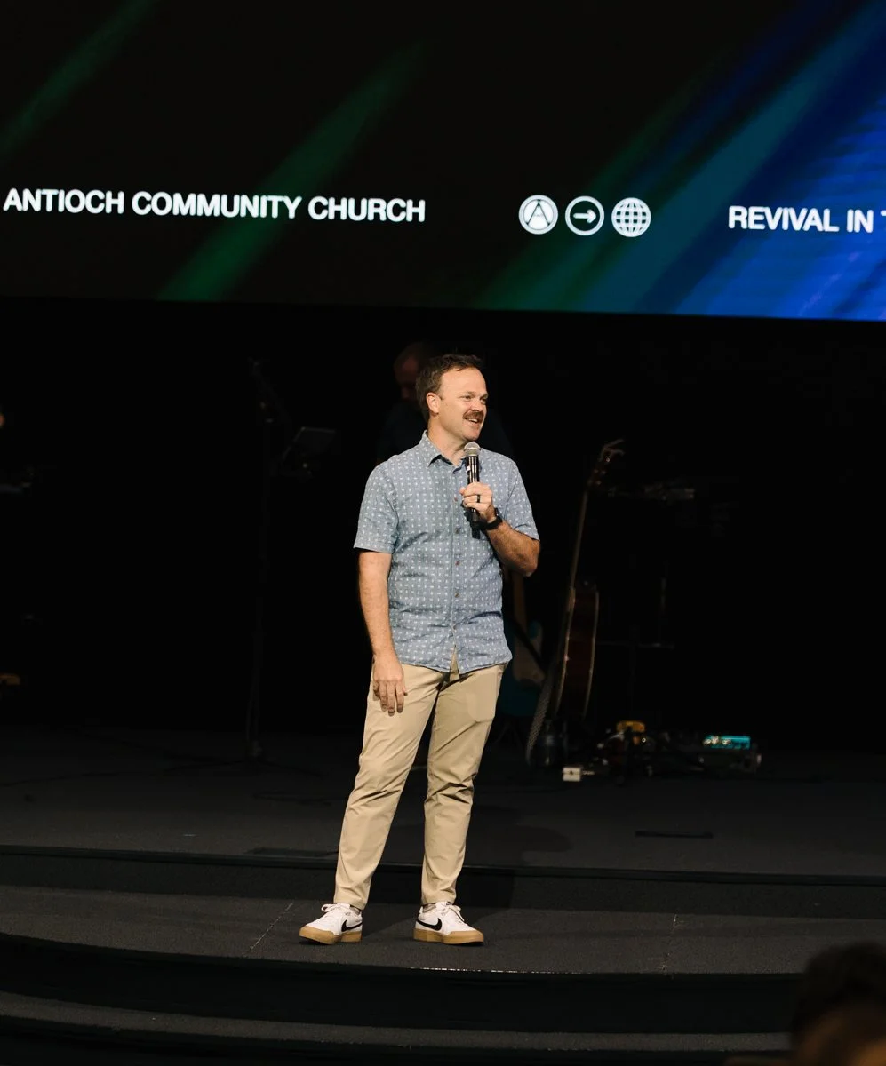 Pastor Travis Phillips of Antioch Community Church preaching at a Sunday worship service.