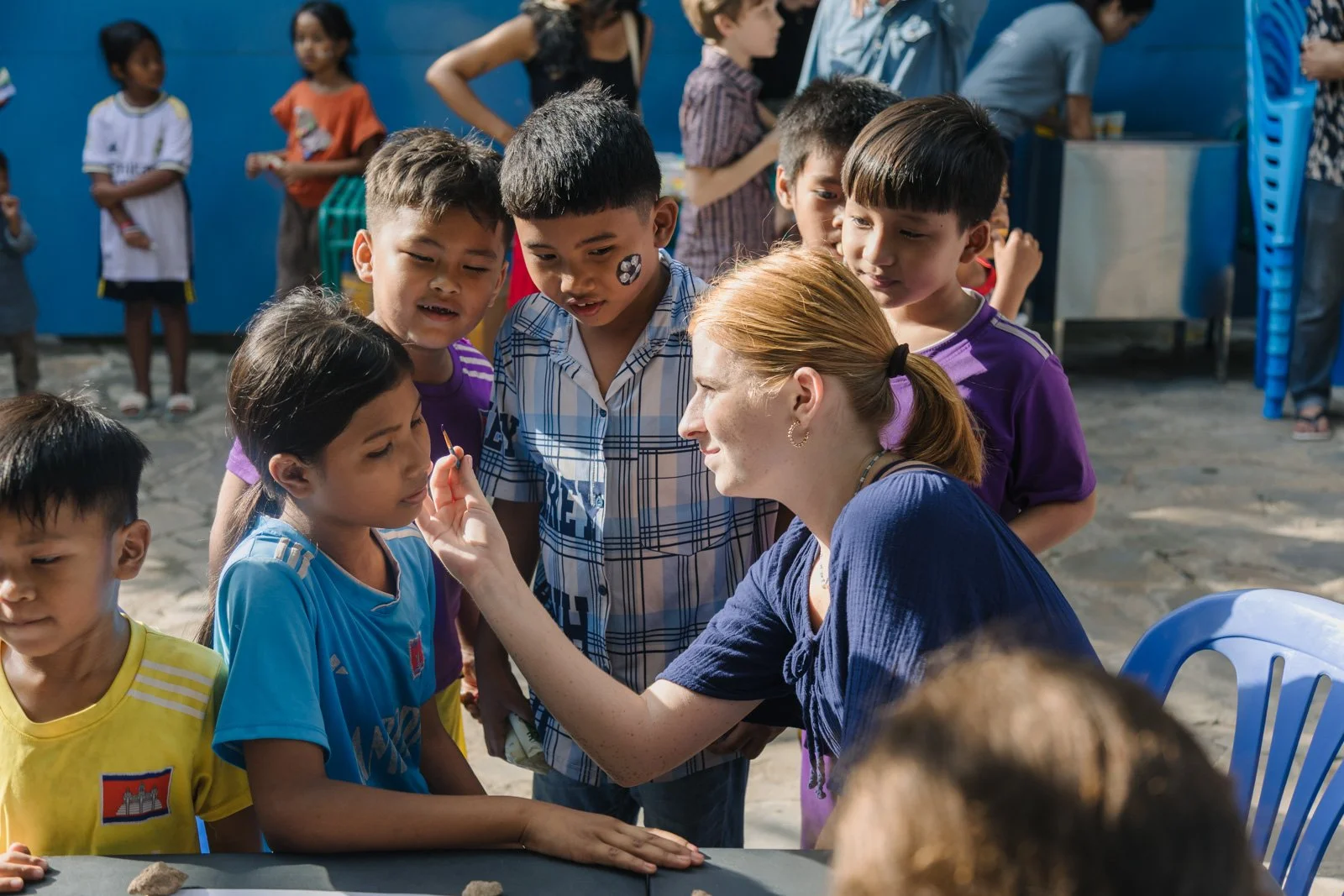 A  girl from Antioch Community Church painting children's faces