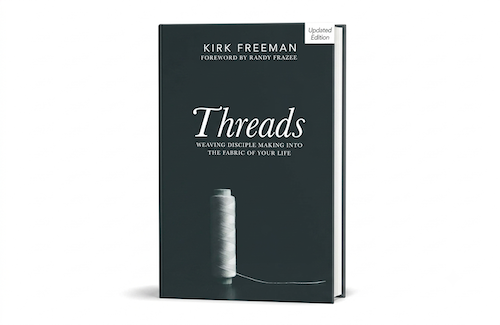 Book titled 'Threads' with a spool of thread on the cover