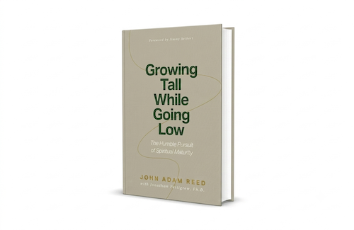 Book titled 'Growing Tall While Going Low' by John Adam Reed.