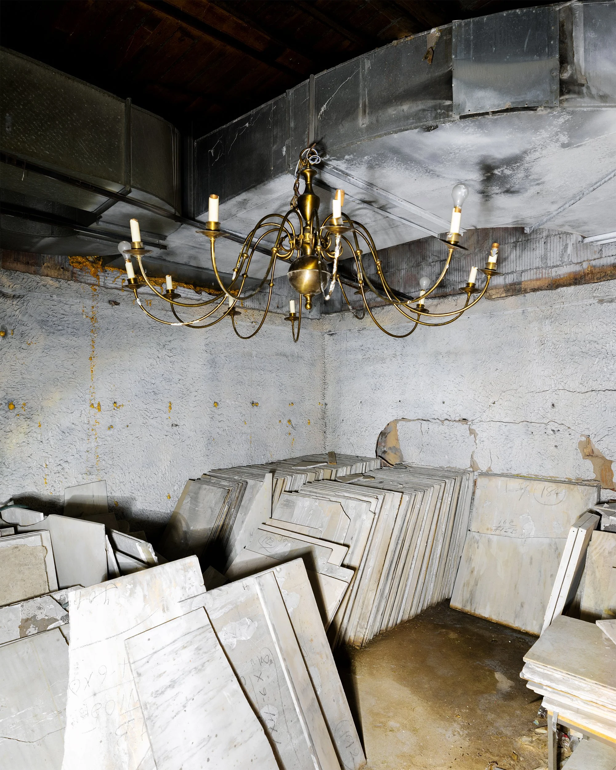 Original 1926 chandelier and salvaged marble discovered inside a hidden room in the historic Pittsfield Building during restoration.