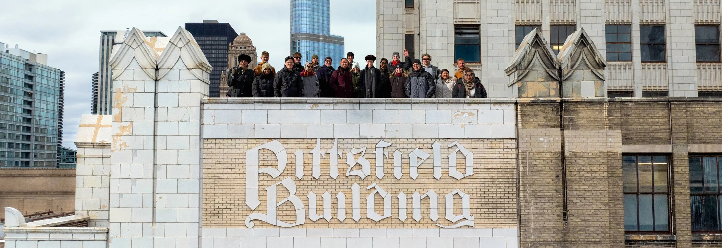Skyscraper Guy community gathered on the 23rd-floor roof of the Pittsfield Building beside the original 1927 terra cotta building lettering.