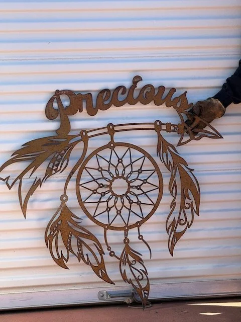 The dimensions on the photos of the native and the dream catcher are each 40 inches tall, just over 3 feet.