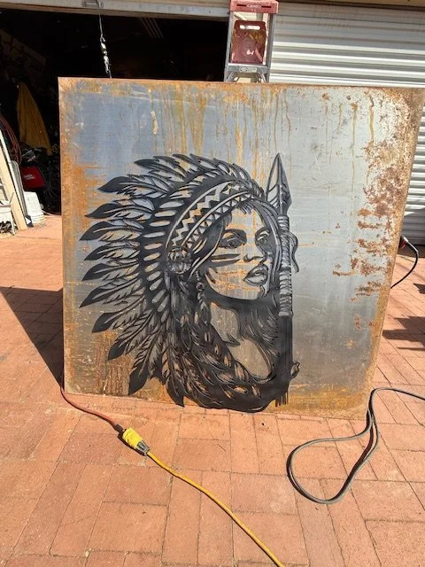 The Native girl is 1/8 inch steel. the dimensions on her are 40 inches high and 34 inches wide. Very heavy