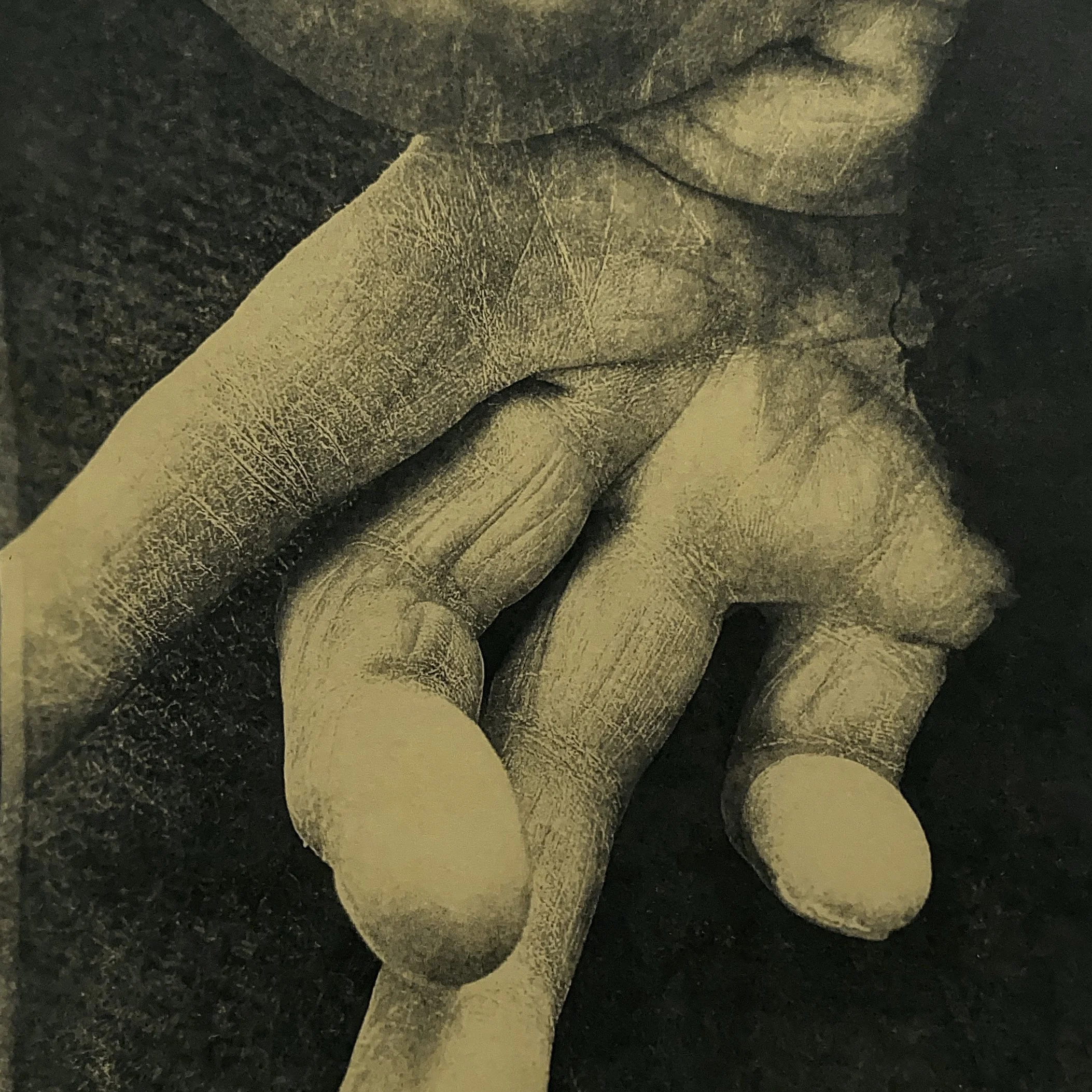 Vintage advertisement featuring a statue and a person touching their chin. The text offers a free booklet to strengthen one's voice, promoting a "HE-MAN VOICE."