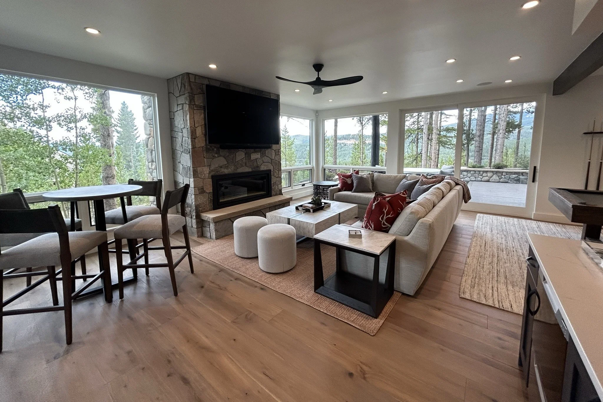 Furnished mountain home living room with sectional, fireplace and forest views in Breckenridge, Colorado by Elle J Design