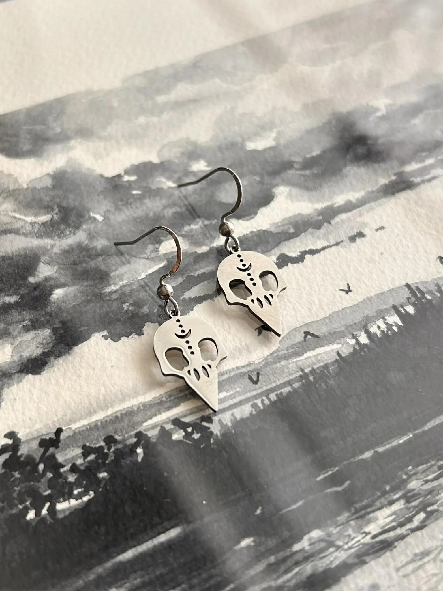 silver earrings raven skull.jpg