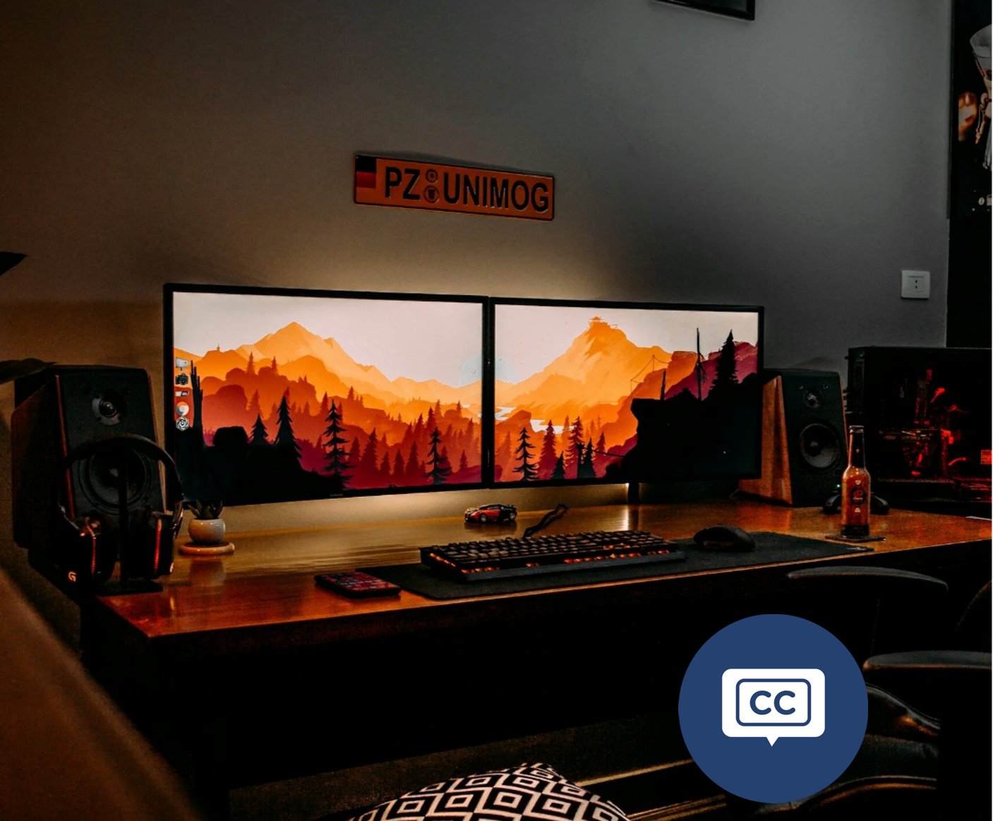 Image of a desk with two wide monitors displaying golden mountains for the Drop-down Sheet Selector exercise. Video tutorial included with full text transcript.