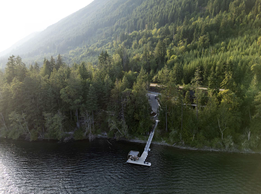 Forested waterfront with a dock near the Vancouver Island retreat