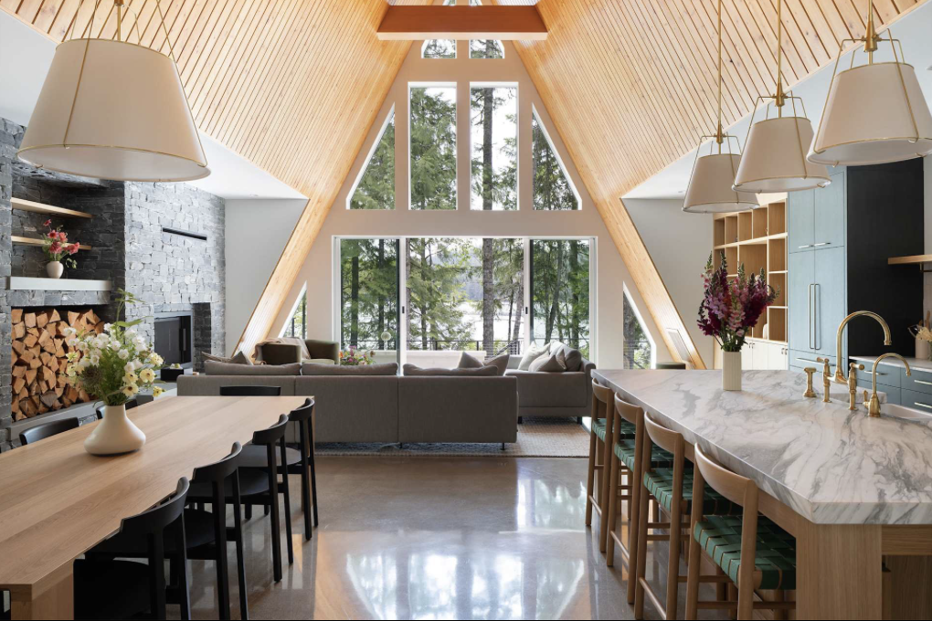 Open-plan living and dining room with tall A-frame windows at the Vancouver Island retreat house