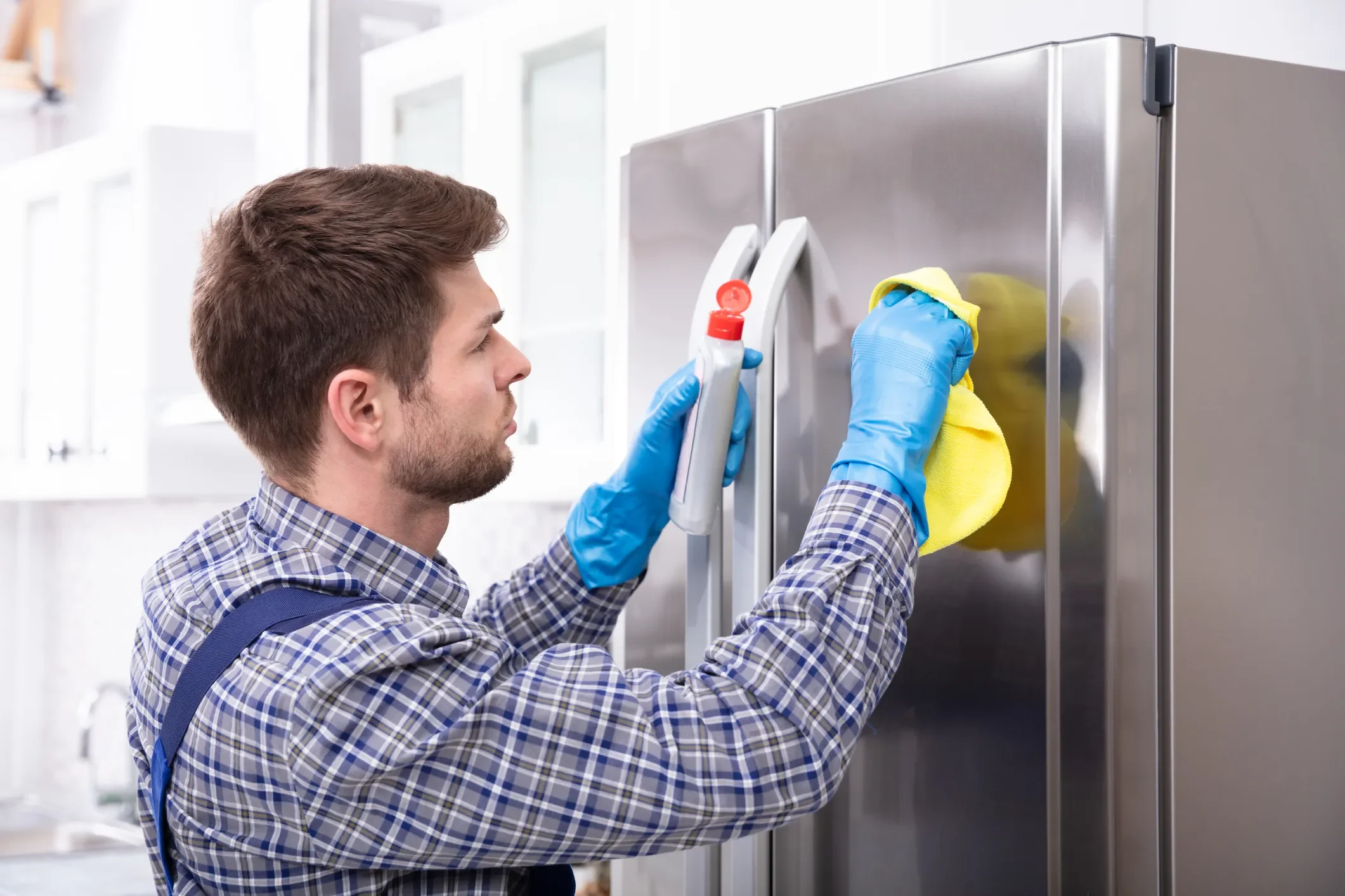 Man Cleaning a fridge