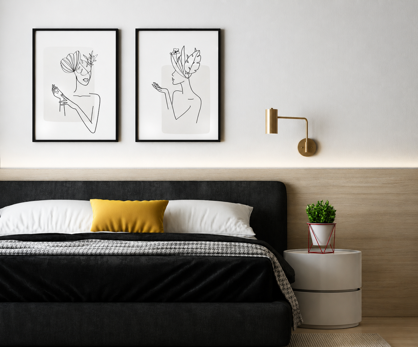 Modern minimalist bedroom with black upholstered bed, yellow accent pillow, framed line art prints, brass wall sconce, and wood headboard panel.